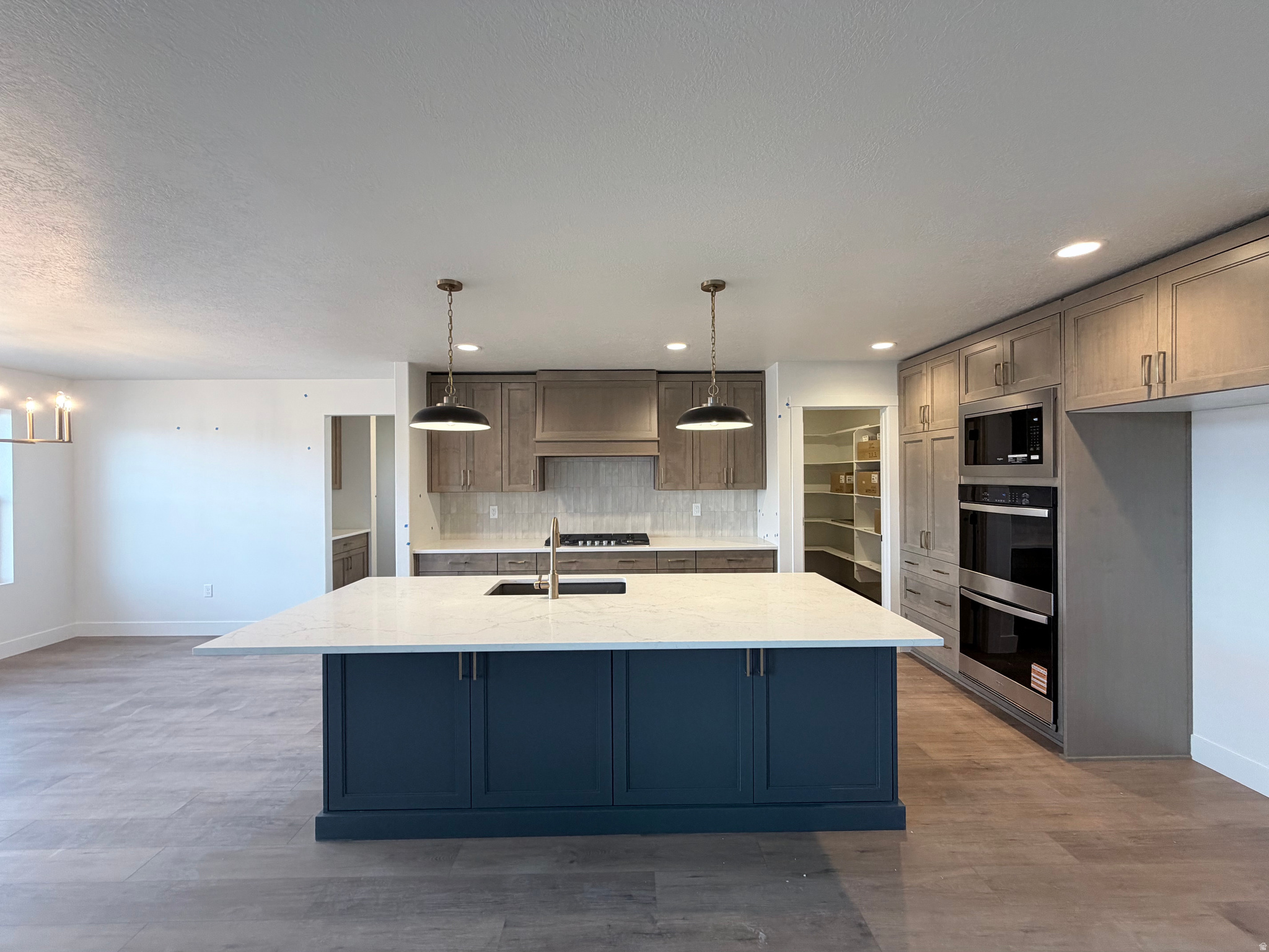 Designed for easy living and unforgettable views, this stunning 4,700 sq ft rambler sits on a manageable lot-perfect for those who'd rather spend weekends enjoying life than maintaining a yard. With a westfacing orientation, the home captures breathtaking mountain views and beautiful sunsets that elevate everyday living.  The unfinished basement gives you the opportunity for added equity and to design it around your lifestyle. The thoughtfully designed floor plan features 3 spacious bedrooms and 2 bathrooms, offering both comfort and functionality. A large 4car garage provides exceptional space for vehicles, storage, toys, and hobbies, while the walkout basement adds flexibility and future potential. At the heart of the home is a beautifully appointed kitchen, showcasing custombuilt cabinetry, a striking decorative hood over the 36inch stove, double ovens, and an oversized center island ideal for gathering and entertaining. A large walkin pantry keeps everything organized, and the convenient pocket office creates the perfect spot for work, homework, or household management. Every detail of this home blends quality craftsmanship with effortless living-set against the backdrop of mountain views and designed for those who value both space and simplicity.