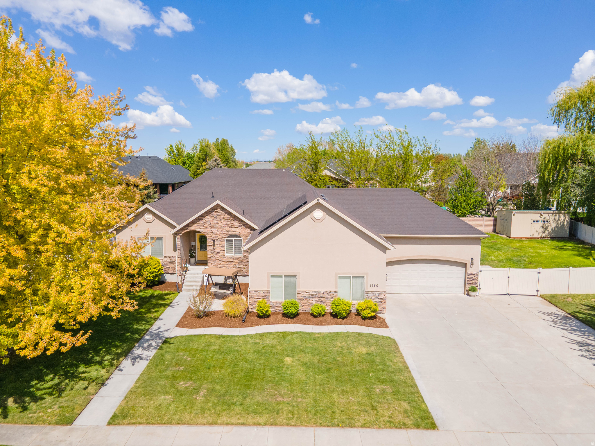 Welcome to this beautifully maintained rambler in a quiet, established Kaysville neighborhood, set on a rare and expansive .43-acre lot. The impressive yard is a standout feature-fully landscaped, fenced, and filled with mature trees, offering flat, usable space that's perfect for outdoor living, entertaining, play, or future possibilities. A covered patio provides the ideal spot to relax and enjoy the generous outdoor setting.  With 6 bedrooms and 3.5 bathrooms, this home offers exceptional space, functionality, and flexibility. The open-concept great room with vaulted ceilings creates an inviting atmosphere for everyday living and entertaining, complemented by freshly painted walls throughout. The thoughtfully designed layout includes a fully finished basement, providing abundant living space, storage, and room to grow. Major system updates provide peace of mind, including a newer furnace and A/C (2022), a new dishwasher (2023), and two new water heaters (2026).  The oversized 3-car garage is another highlight, offering extra height, length, and width-perfect for larger vehicles, hobbies, or additional storage-along with dedicated RV parking for even more versatility. Save additional money with the paid off solar panels, which were installed in 2017. Conveniently located with quick access to I-15 and the Davis Corridor, commuting is easy whether heading to Hill Air Force Base or Salt Lake City. With its combination of expansive outdoor space, a highly functional layout, and a prime west Kaysville location, this home is a rare opportunity.  Sellers are including both refrigerators, both washer and dryer sets, as well as the shed, swing set, and hot tub-adding even more value and making this home truly move-in ready.  Matterport walk through of home: https://my.matterport.com/show/?m=kjL8mVPnW4r