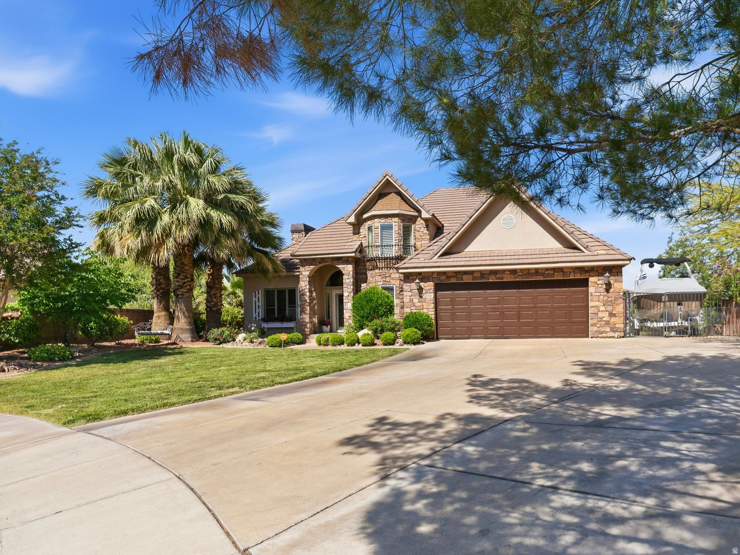 Nestled on a private .39 acre lot in scenic St George, this storybook home offers a perfect balance of convenience and tranquility -just minutes away from everything you would need, dining, shopping, banking, gym and everyday amenities, while still feeling tucked away in a private and peaceful cul-de-sac. This beautifully remodeled 4200 sq ft home features 4 bedrooms and 4 bathrooms, 2 kitchens, 2 laundry rooms, dedicated office, loft, den, and formal dining. Updates throughout include new flooring, fresh paint, updated countertops, and new air conditioning units. Designed with versatility in mind, the home is ideal for multi-generational living, an ADU set up, or rental income potential with NO HOA restrictions. The cozy living areas are flooded with natural light. Whether you are seeking a peaceful retreat or an entertainers dream, this home provides it all. Outside you will enjoy the breathtaking view of Snow Canyon, providing a tranquil and scenic back drop from your private oasis, including an inviting pool and hot tub, surrounded by mature palm trees. You will enjoy endless RV parking for all your toys. The drive-thru RV makes it a haven for outdoor enthusiasts including a detached garage or workshop.   Square footage figures are provided as a courtesy estimate only and were obtained from ____MLS__________ .  Buyer is advised to obtain an independent measurement.
