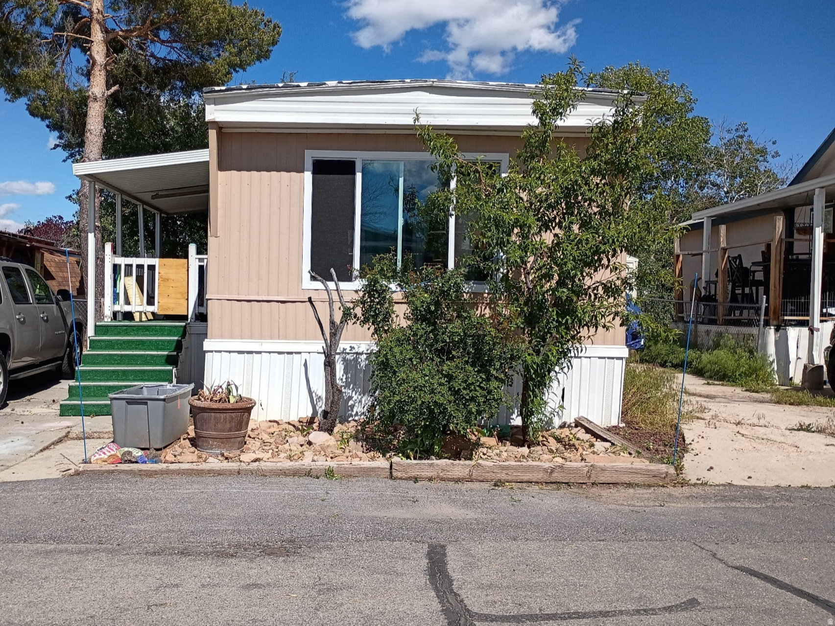 Has two parking spaces that can fit up to 4 cars. New window in kitchen, new floors in a bedroom, paint, refurbished tub, new fridge, island table in the kitchen, deep freeze. Has matured apple and peach trees.  Washer dryer included.
