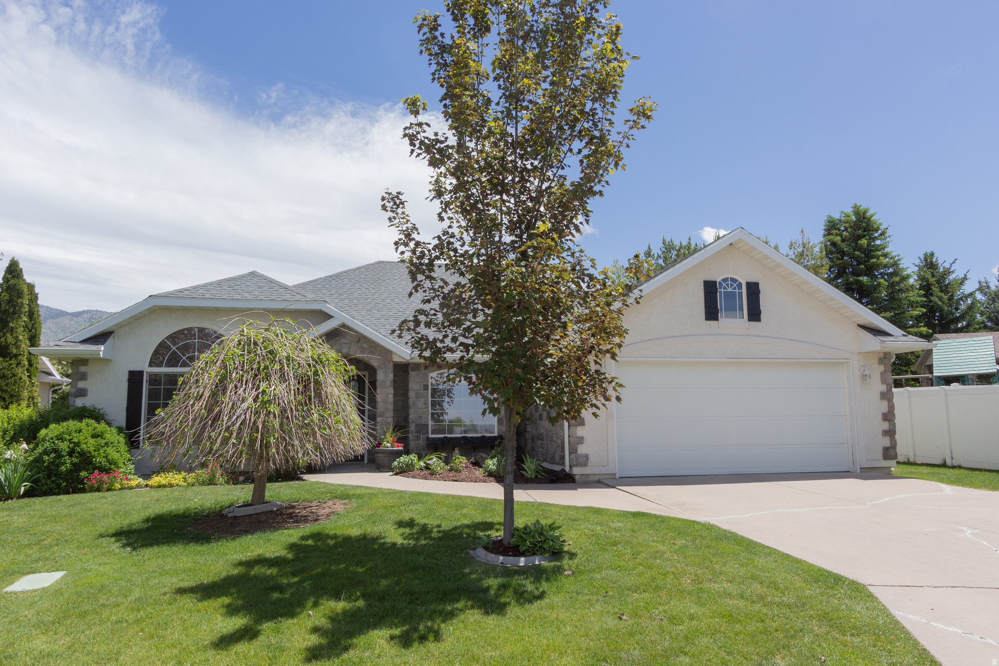 You will love this bright & classy updated single-level home located in a desirable 55+ community in North Logan! This home has a beautiful kitchen with white cabinets & quartz countertop, large center island, wonderful large windows with views of the mountains and the fenced backyard.  There are doors from the dining area & master bedroom to the patio and pergola. This 1,636 sq ft 2 bedroom, 2-bathroom home has a formal living room/office with French doors, formal & semi-formal dining areas and vaulted ceiling in the family room with gas fireplace. Situated on a prime inside corner lot, the property features a peaceful backyard retreat with flower gardens, raspberry bushes and strawberries.  Other updates include, newer shingles, new carpet and paint.  Conveniently located near the HOA park and picnic area, shopping, dining, and Utah State University, this home offers easy living and convenience!