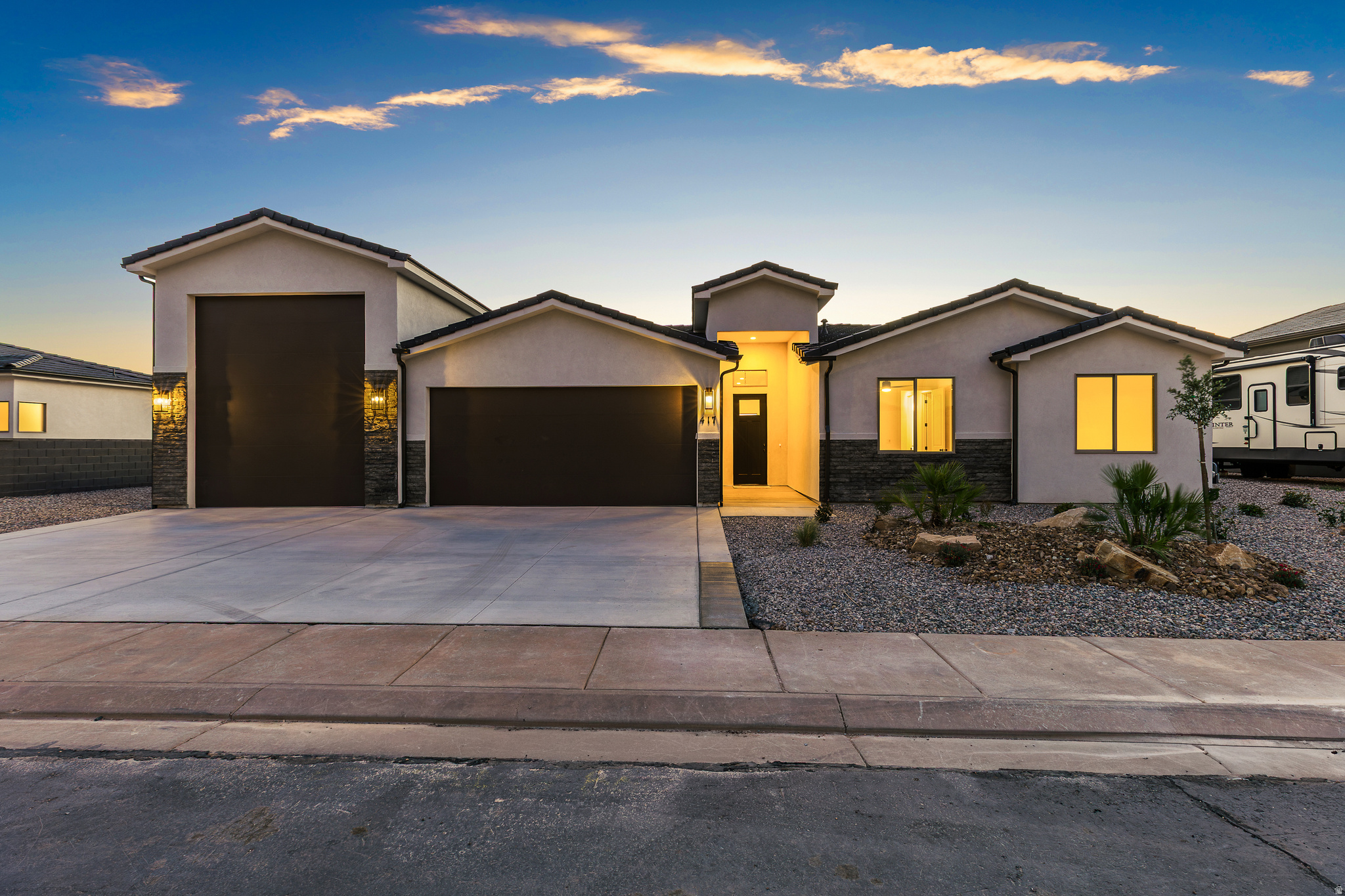 Modern design, open layout, and plenty of room for storage, toys, or adventure-ready living. The RV Garage features a 12' wide door with 14' of height with the depth a little over 48'. The kitchen features quality wood cabinets, quartz countertops, and black plumbing fixtures. The large island is perfect for entertaining. The primary suite offers a walk-in closet and unobstructed view of Pine Valley Mountain. Enjoy the convenience of single-level living with stylish touches and ample storage for everything you need. Contract the listing agent to schedule your showing today.