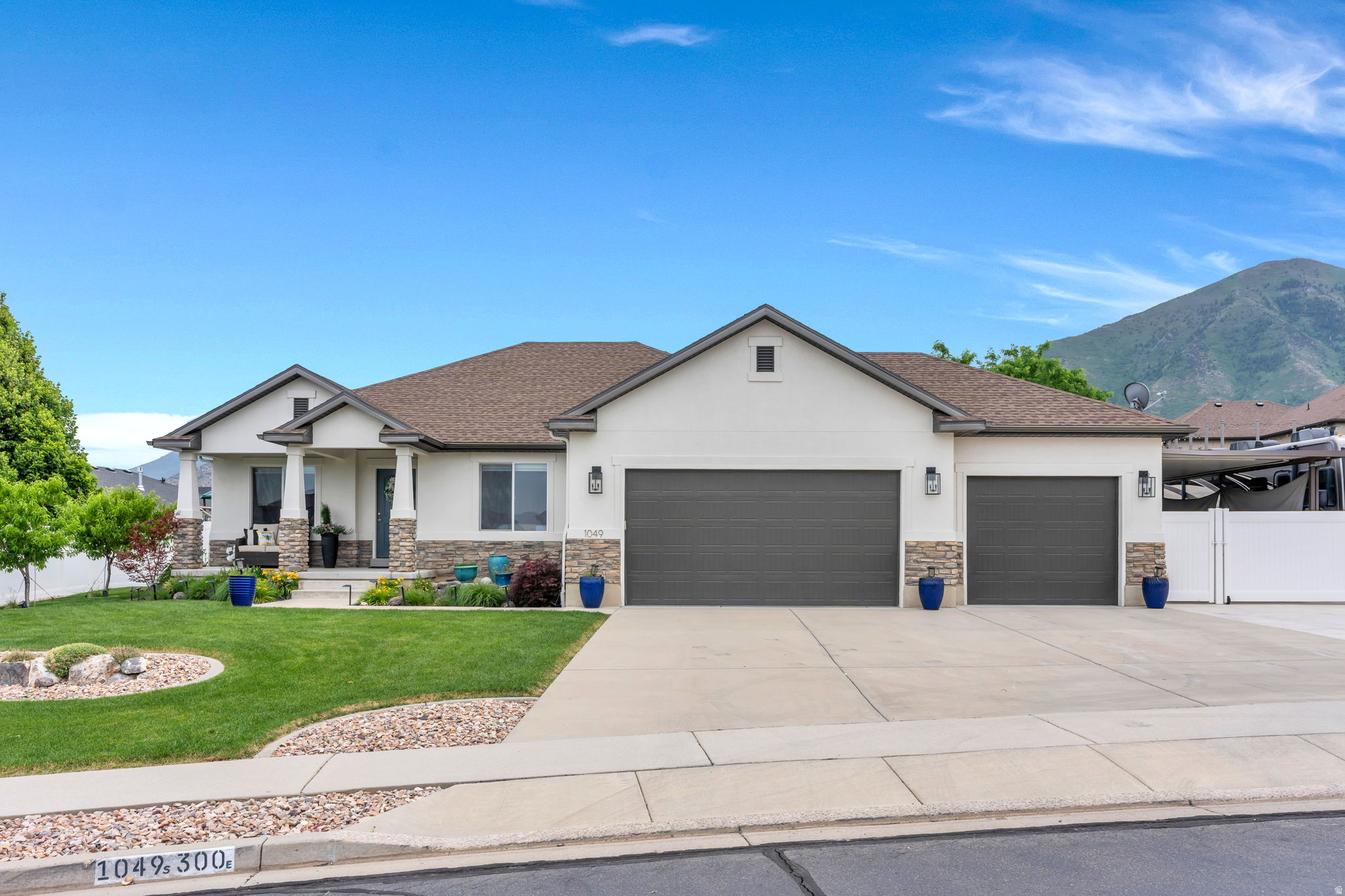 No showings until the open house. ***OPEN HOUSE - SATURDAY JUNE 13, FROM 10 AM - 1 PM***The perfect new home! Not a thing to do, sellers have done it all for you!  Modern clean lines, newly painted and completely updated with gorgeous floor to ceiling.  Austin stone fireplace, white cabinetry, solid white oak floating shelves and mantle,dark luxurious granite countertops, custom window treatments throughout.Master and two bedrooms, two baths on the main floor. Downstairs there are 2 more bedrooms, 3rd bathroom, bath, playroom or 2nd theater room, huge great room with sleek modern fireplace and custom lighting, more cabinetry and floating shelves, 2nd full kitchen with quartz countertops, and 2 large storage rooms Outside you will find a large covered front porch perfect for viewing sunsets, mountain and lake views, a 3 car garage with professional epoxy floors, large covered area by Utah awnings for parking 3 more vehicles, toys, work area, entertaining or whatever you can imagine! Motorhome pad, large 8x10 Tuff shed, and all the concrete parking you could want - enough for 7 additional vehicles. There is a play area for the kids or grandkids with a newer lifetime playset and in-ground trampoline, a huge 14x26 covered patio for outdoor dining and lounging, an above ground pool, fire pit,custom concrete edging and stone all around, 5 large raised planter beds with automatic drip system, as well as strawberries, blackberries and raspberries, peaches, apples, nectarines, apricots, and cherry bushes It doesn't get any better or easier than this! Stainless steel appliances. Most appliances were replaced a year ago includes 2 fridge, 2 ranges, 2 microwaves, and an upright freezer. Play set and above ground pool stay with a full price offer.  Preferred lender will provide credit of up to 1% of the loan amount on Conventional and VA loans.  **Solar/batteries, charger are not included.Drapes and hardware in living room and mastr bedroom are excluded.  See exclusion remarks.
