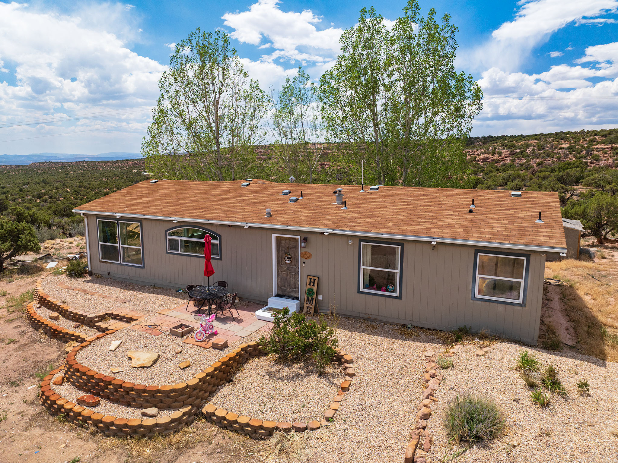 Designed to capture the stunning scenery, the home features expansive windows and sliding glass doors that fill the living spaces with natural light while showcasing the incredible lake and mountain views. Inside, you'll find thoughtful updates throughout, including freshly painted kitchen cabinets, a beautifully remodeled primary bathroom with a custom tiled shower, and the cozy warmth of a pellet stove for those cooler evenings.  The functional floor plan offers convenient single-level living, with a versatile den that could be converted into a third bedroom, home office, or hobby space to fit your needs.  Outside, there's plenty of room for horses or other animals, recreational vehicles, trailers, and all your outdoor toys. Whether you're looking for a peaceful full-time residence, a weekend getaway, or a property with space to expand, this exceptional acreage offers endless possibilities.  Square footage figures are provided as a courtesy estimate only and were obtained from county records .  Buyer is advised to obtain an independent measurement.
