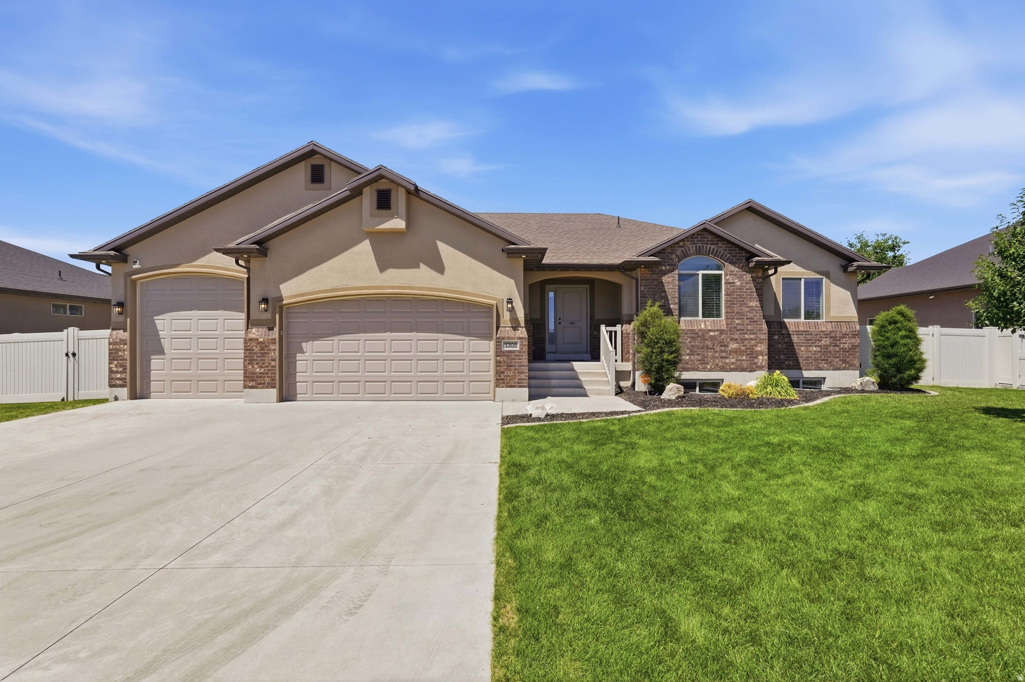 Experience the perfect blend of space, functionality, and outdoor living in this beautifully maintained rambler located in one of Clinton's newer neighborhoods, offering stunning mountain views and room to grow. The standout feature of this home is the incredible covered back patio, thoughtfully designed as an extension of the home's roofline. Complete with recessed lighting and a retractable roller shade, this outdoor retreat creates the perfect setting for relaxing summer evenings, outdoor dining, and entertaining guests while enjoying the surrounding mountain scenery. The backyard also features beautifully manicured garden areas and an included storage shed for added convenience. Car enthusiasts, hobbyists, and adventurers will appreciate the exceptional 4-car garage with a 220 amp, 30 amp wired to an outlet, and gas line in the garage. In addition to ample parking, the garage includes an oversized, extra-deep RV bay with a 10-foot garage door, providing rare indoor storage for recreational vehicles, boats, or oversized equipment. Included storage racks help maximize organization and functionality. Inside, the main floor showcases an open-concept layout that seamlessly connects the kitchen and family room, creating a welcoming space for everyday living and gatherings with family and friends. The kitchen is highlighted by an oversized walk-in pantry, providing exceptional storage for groceries, small appliances. The spacious primary suite offers  an oversized walk-in closet with a window. This versatile space is large enough to accommodate a home office, exercise area, or nursery, while still providing abundant wardrobe storage. Downstairs, the partially unfinished basement offers endless possibilities. Whether you're looking for substantial storage space or envision a future home gym, theater room, recreation area, or additional living space, this expansive area is ready to fit your needs. With exceptional garage space, versatile living areas, and one of the most inviting outdoor entertaining spaces you'll find, this beautiful home won't stay on the market long.  Dimensions for the extra garage space: 22' 7" deep by 13' 4" wide. 11 ft ceilings.  Covered patio dimensions: 24' 10" and 13' deep. Shed dimensions 14' by 8'