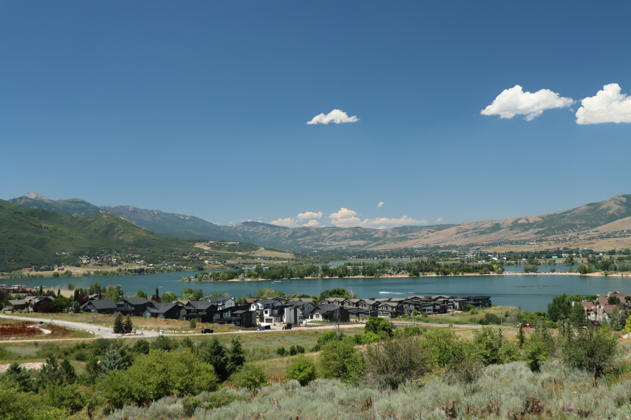 Stunning view lot with water hookups previously acquired and maintained. Prestigious gated community with lake and mountain views. Corner sloped lot for a variety of access and floor plan design. Lot designed architectural plans available if desired. Backs onto Snow Basin Property, minutes to other resorts, golf, boating and? Fun resort in valley community. Within 20 mins of Ogden and 45 mins to SLC / airport. Included is link to HOA website and are video. Will need code for access. https://www.summitatskilake.com/ Agents are appreciated.