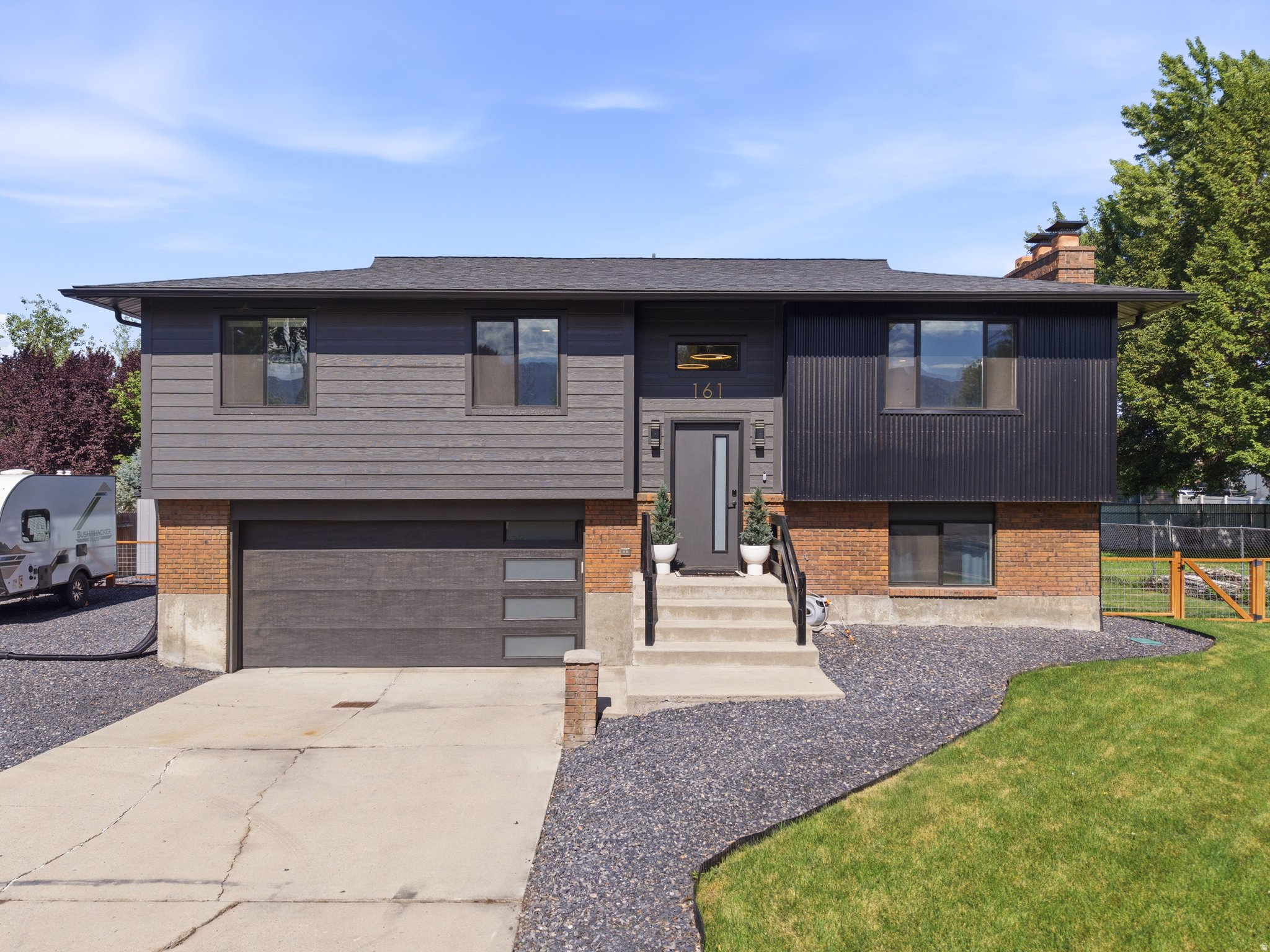 This fully remodeled Provo split entry has a moody, designer feel you don't often find at this price point. Rich dark tones, layered textures, and lime wash feather finish accent walls set the tone the moment you walk in, opening into a bright great room with a cozy fireplace and custom built ins that make the space feel both curated and comfortable. The kitchen carries that same intention through new cabinets, countertops, and appliances, while downstairs the fully finished walkout basement offers a flexible bedroom, a three quarter bath, and covered patio storage tucked beneath the deck. Step outside and the care continues, with new Hardie board siding, a new roof, windows, and gutters, fresh landscaping, and an expansive deck overlooking a fully fenced backyard with RV parking and a storage shed. Under the surface, a new furnace, water heater, and updated electrical mean the big ticket items are already handled. Just minutes from the Provo River Trail, Provo Airport, and Utah Lake Marina, this one blends style and substance in a way that's hard to find. Come see it for yourself, this home won't last.