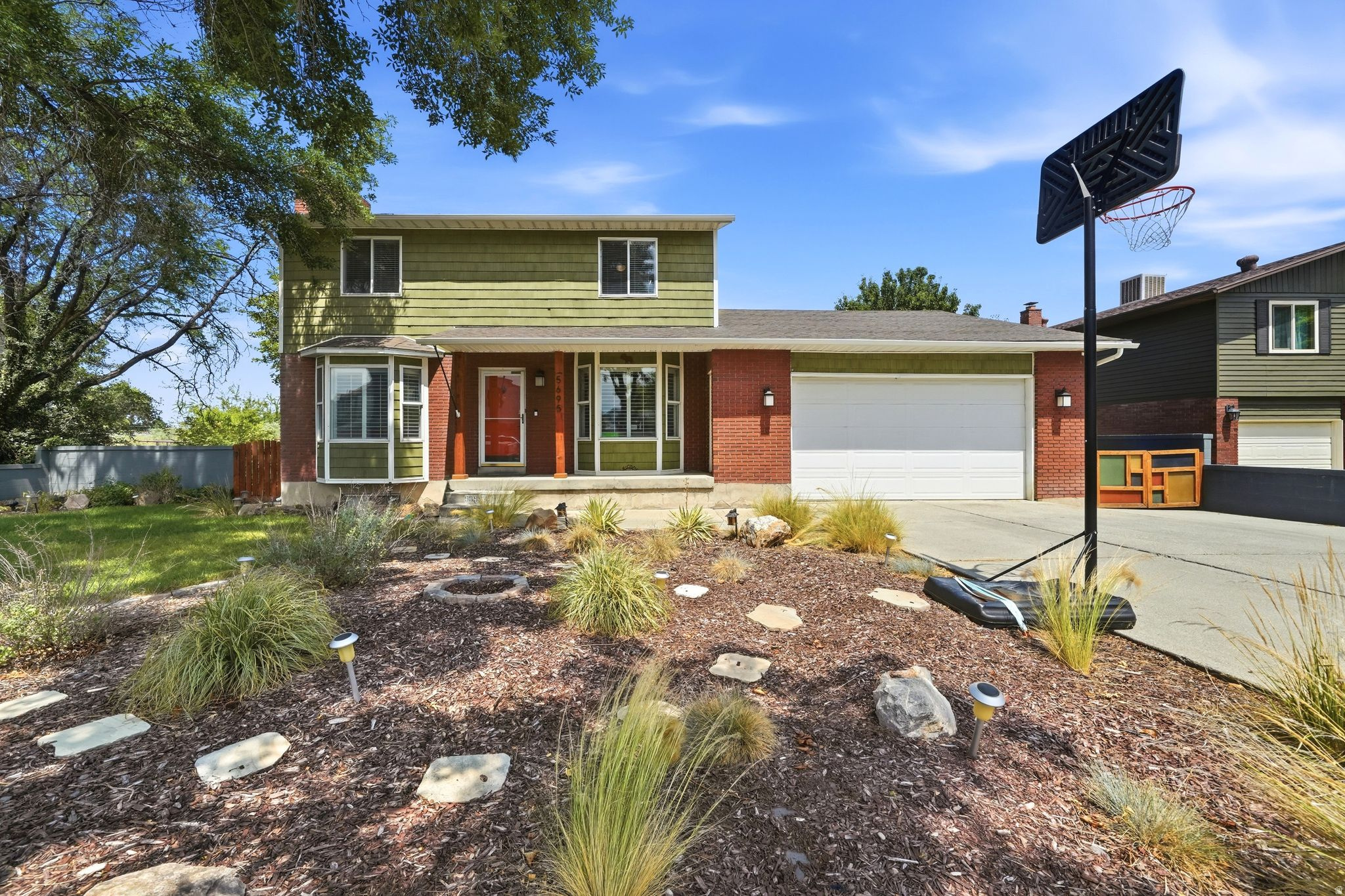 Nestled on a quiet cul-de-sac with no through traffic, this beautifully maintained home offers a peaceful setting with mature trees and a canal running behind the property. Conveniently located just around the corner from an elementary school and only minutes from major shopping, dining, and everyday conveniences, you'll also enjoy being approximately 20 minutes from nearly anywhere in the Salt Lake Valley.  Inside, you'll find a spacious and functional floor plan with bedrooms on both the upper level and in the basement, providing flexibility for families, guests, or a home office. The large kitchen offers abundant space for cooking, gathering, and entertaining, while the beautifully landscaped yard creates the perfect outdoor retreat. A rare attached shop behind the garage provides exceptional space for hobbies, storage, or projects. With no HOA, a versatile layout, and an unbeatable location, this home is a fantastic opportunity.