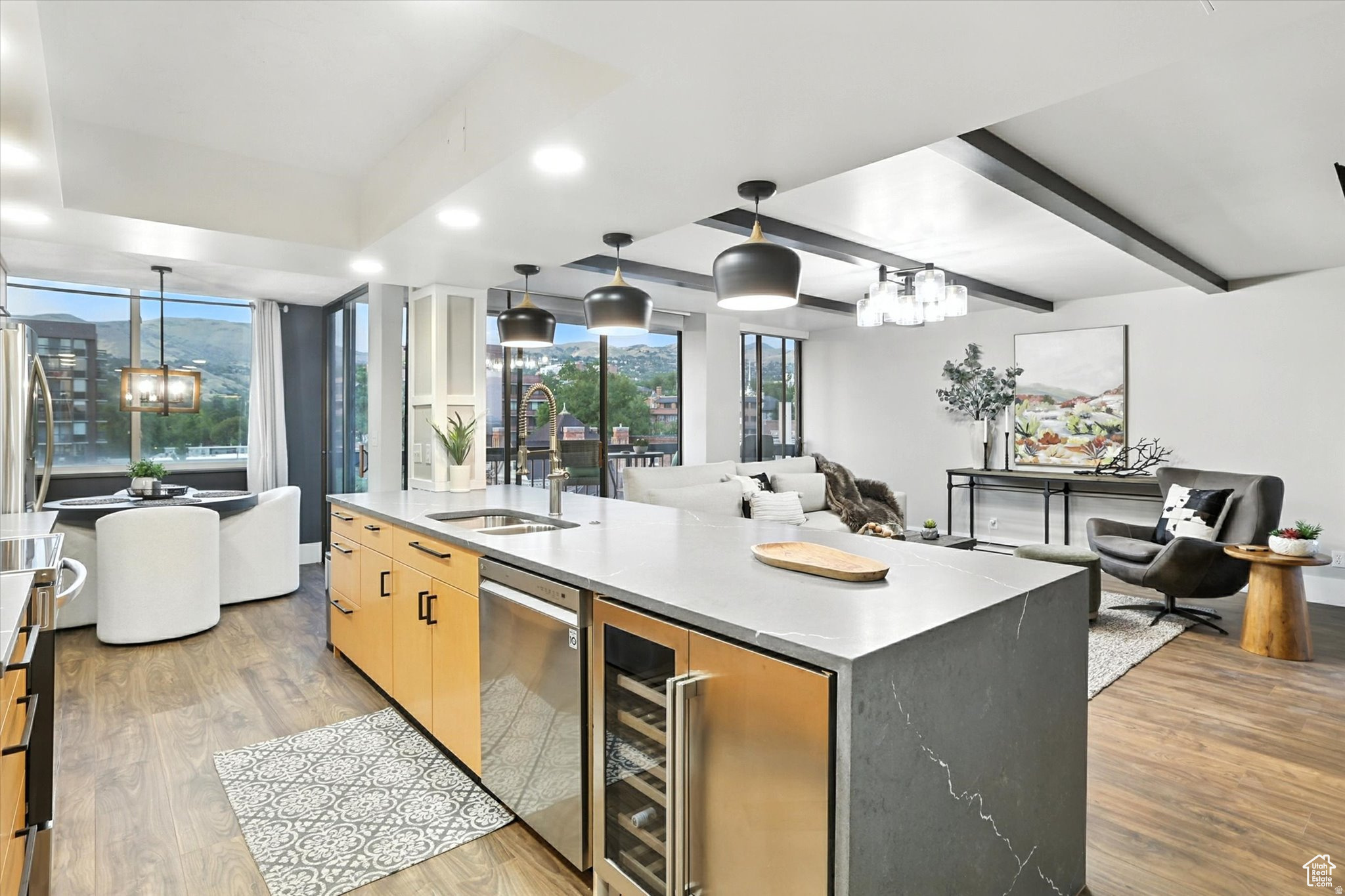 OPEN HOUSE Friday, July 17th from 6:30-8:30pm. Discover the perfect fusion of urban sophistication and tranquil luxury in this completely transformed rooftop penthouse that serves as your gateway to the ultimate Salt Lake City lifestyle. Nearly every surface has been thoughtfully updated including a stunning kitchen with quartz marble countertops, premium appliances, and open breakfast bar, plus three private bedroom suites with fully remodeled bathrooms featuring new floors, vanities, custom showers, and designer lighting. Offering exceptional flexibility, two suites are located on the main level and can function as primary suites, while the upstairs suite opens directly onto the expansive private rooftop deck-making it an ideal guest retreat, secondary lounge, or incredible indoor/outdoor entertaining space. A 2022-installed heat pump and AC system provide year-round comfort. What truly sets this property apart is the exclusive rooftop deck with unobstructed mountain vistas and spectacular sunset views-your own private piece of the sky, perfect for entertaining or unwinding above the city. Located minutes from Temple Square, City Creek Center, multiple parks, and surrounded by incredible dining, true walkability puts Salt Lake's best at your fingertips while downtown's connectivity keeps you perfectly positioned for skiing, flights, or entertainment at the Delta Center. Two deeded parking spaces, generous guest parking, large private storage unit, and a dedicated office/flex space ensure convenience matches comfort in this elevated living experience where luxury amenities meet unparalleled access to everything that makes Salt Lake City extraordinary.