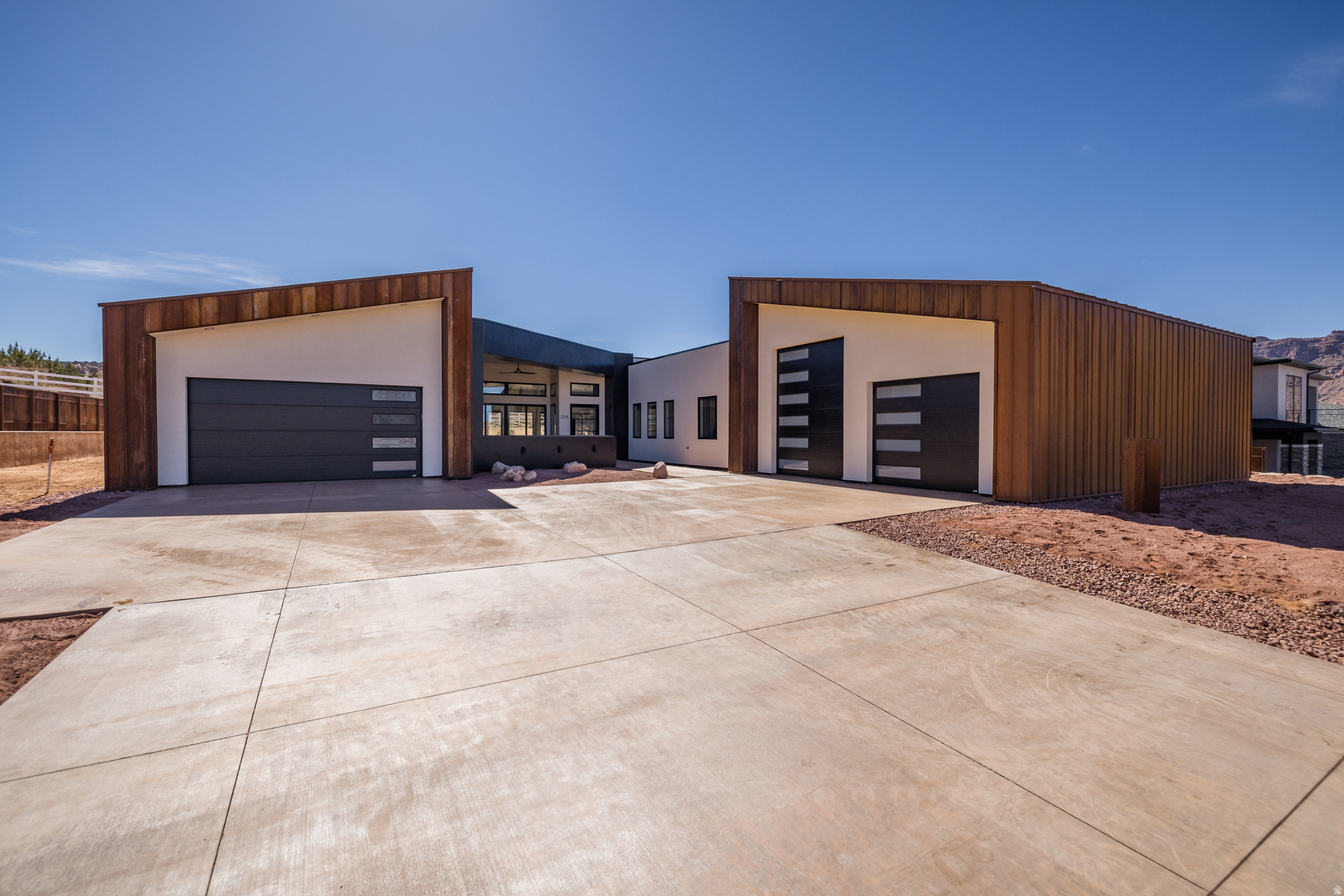 STUNNING NEW BUILD featuring sleek, contemporary design- newly re-designed and re-imagined!  Set on a spacious .40-acre home site in the Puesta del Sol community with custom orientation for ultimate privacy and views surrounded by red rock and the towering Moab Rim. A soft industrial finish featuring custom metal work, quartz countertops, floor-to-ceiling windows, quality stainless steel appliances, waterproof Luxury Tile floors, Anderson windows & exterior doors, and electric multi-programable fireplaces.  The layout has superior function, celebrating two master en-suites, two additional guest bedrooms with a full bath, and mudroom with laundry.  Both en-suites grant dual sinks, lavish showers with glass doors, and ample closet space. Plenty of space for parking along with an attached 2-car garage with room for a sprinter van, as well as a third car garage with double roll up doors- for your toys or your entertaining room off the front patio!  Square footage figures are provided as a courtesy estimate only and were obtained from images.  Buyer is advised to obtain an independent measurement.