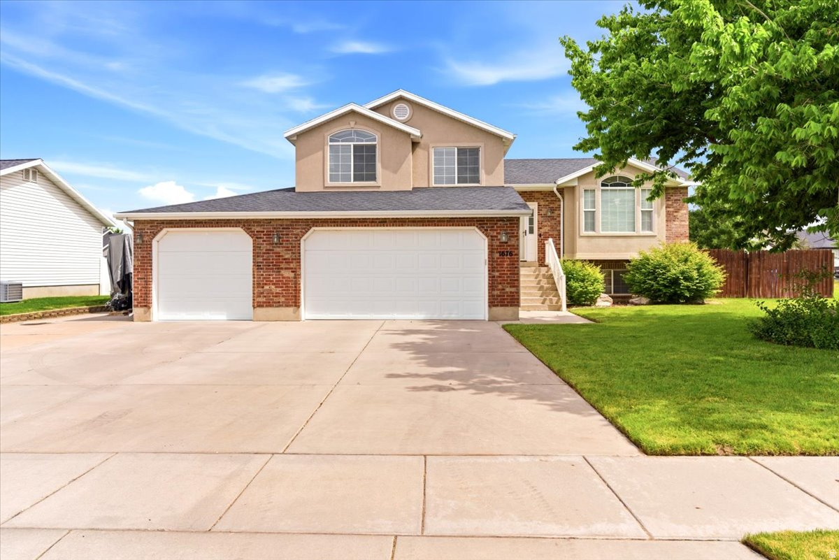 Move-in ready and meticulously maintained, this spacious home offers the perfect blend of comfort, functionality, and location. Featuring large gathering spaces ideal for entertaining, generously sized bedrooms, and a rare tandem 4-car garage, there's room for everyone and everything. Enjoy the convenience of RV parking, a south-facing driveway for easier winter maintenance, and a quiet neighborhood setting. Step outside to a covered patio and established garden spaces, perfect for relaxing or enjoying Utah's beautiful seasons. Conveniently located near schools, shopping, clinics, and hospitals. Within 10 minutes of HAFB, I-15, and the West Corridor, and just 20 minutes from Weber State University.  Square footage figures are provided as a courtesy estimate only and were obtained from county records .  Buyer is advised to obtain an independent measurement.