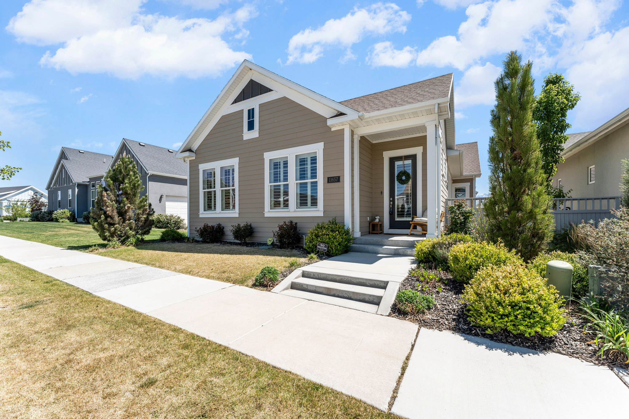 From the moment you arrive, this stunning Daybreak rambler makes an undeniable statement, having been meticulously upgraded throughout with no detail overlooked. Soaring ceilings and an abundance of natural light welcome you inside, where custom plantation shutters frame every window with effortless elegance. The heart of the home is a beautifully open kitchen and family room designed for both intimate evenings and memorable gatherings, anchored by a generous family room with a ceiling fan and flowing seamlessly into a chef-worthy kitchen that features a large granite island with bar seating, modern pendant lighting, stainless steel appliances, a subway tile backsplash, gas range, newer dishwasher, large pot filler drawers, and a well-appointed pantry. A semi-formal dining space adds a touch of sophistication to everyday meals and opens conveniently to a covered side patio, the perfect retreat for a quiet morning with a book and something warm in hand. A private home office with plantation shutters, vaulted ceilings, and French doors offers an inspiring and productive workspace, while the expansive primary suite delivers a true sanctuary complete with abundant natural light, a ceiling fan, and direct patio access ideal for those slow, peaceful mornings. The en suite bath is nothing short of spectacular, showcasing double sinks, beautiful tile floors, a stunning three-quarter shower with European glass and a rain showerhead, and a large walk-in closet. A well-sized second main-level bedroom with plantation shutters and tall ceilings shares a beautifully appointed full bath with modern tile flooring and granite vanity, and a conveniently located laundry room with ample cabinetry rounds out the main floor. The fully fenced yard is low maintenance and move-in ready, while the basement rivals the main level in every way, offering an expansive open family and recreation room perfect for game nights and holiday entertaining, two oversized bedrooms including one that rivals a primary suite in size and comfort, and two full bathrooms with tile floors and granite vanities, a rare and coveted feature. The basement also provides exceptional storage with built-in shelving throughout. Additional highlights include a freshly re-stained and repainted fence with a three-year warranty, cordless blinds installed on the majority of windows for energy efficiency and sun protection, and beautifully planted roses lining the fence that bring a charming, personal touch to the outdoor space. Residents enjoy Daybreak amenities such as parks, trails, pools, a fitness center, and lake access. Conveniently located near schools, shopping, dining, and major commuter routes. This home is truly one of a kind. Schedule your private showing today. Buyer and Buyers agent to verify all information. Square footage figures are provided as a courtesy estimate only. Buyer is advised to obtain an independent measurement.