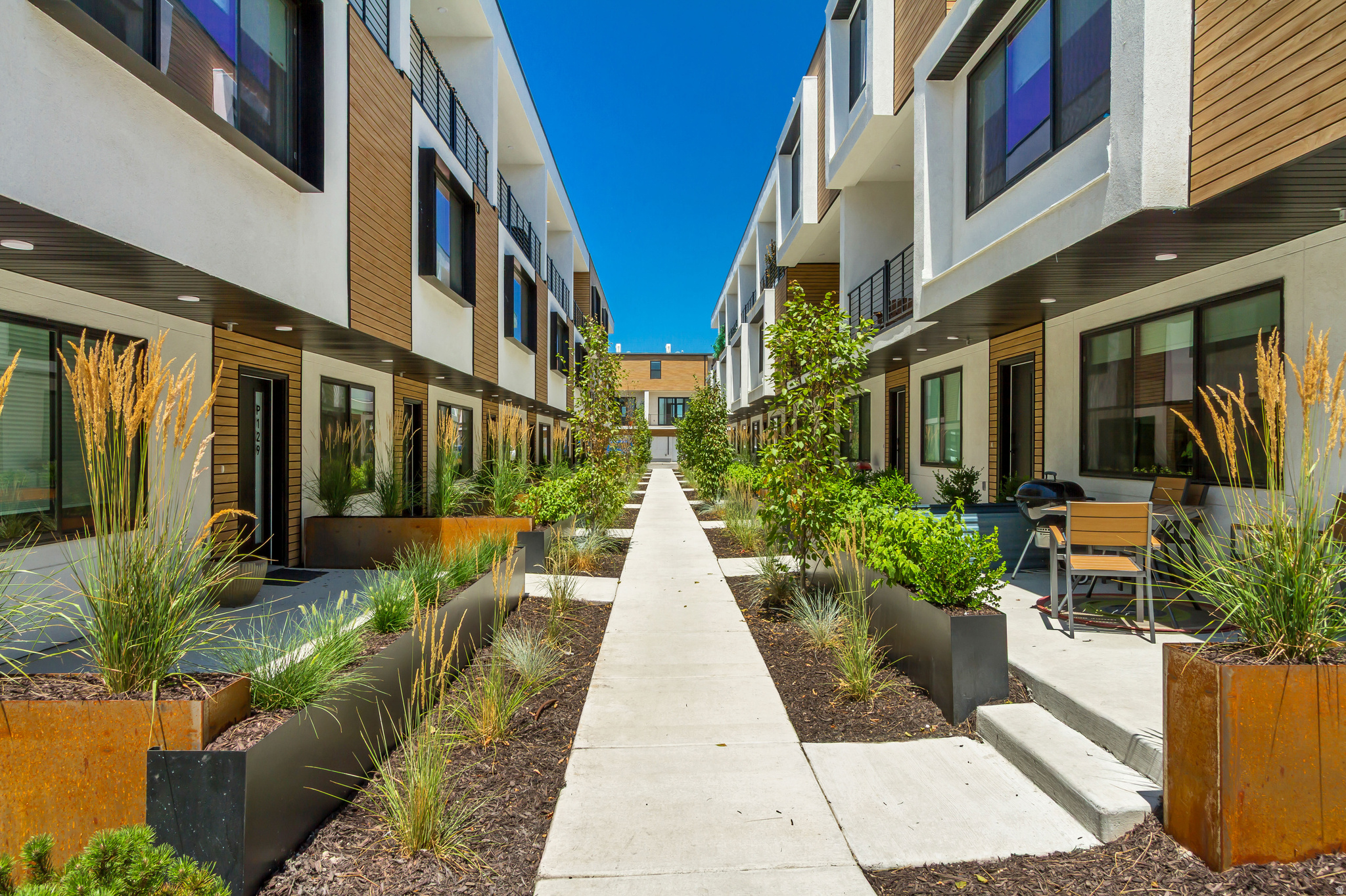 Now offering $6,000 in buyer incentives to use towards closing costs, rate buy down or appliances.    FOR THE OPEN HOUSE, PLEASE COME TO THE MODEL LOCATED AT UNIT B104.  Welcome to Opus Green. Experience the perfect harmony of modern comfort and environmental stewardship. Opus Green Townhomes offer a range of floor plans, including 2 and 3-bedroom townhomes, designed with meticulous attention to detail. From the spacious great rooms and gourmet kitchens to the tiled showers and open stair railings, every aspect of Opus Green exudes sophistication and elegance for your comfort. This modern townhome community is all-electric with 9'7" cathedral ceilings, tiled showers and tubs with glass doors. Best in class, ductless, wall-mounted mini split air conditioners.  Quartz countertops and a one of a kind floorplan not seen before. This 2 bed 2.5 bathroom oasis will leave you green with envy. The 2 car garage with EV charging station, 1 touch smart home temperature control app and package storage/delivery service "Fetch Package", are just a few more added benefits to this zero emission environmental living townhome. Embrace a life of unparalleled comfort, elegance and fulfillment in the dwelling you've been longing for.