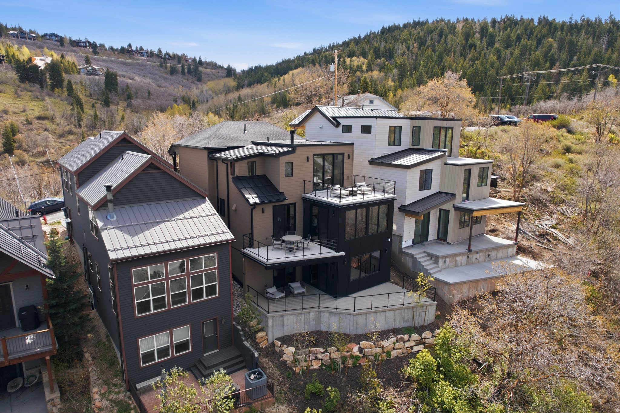 Perched above Historic Main Street in a quiet Old Town setting, this newly constructed residence offers refined mountain living with exceptional privacy, south facing views up and down the valley, abundant natural light, and easy walkability to the heart of Park City. Elevated above town, the home provides a true sense of separation while remaining moments from Old Town's dining, shopping, and entertainment. Spanning 3,030 square feet, it blends modern architecture with warm, livable spaces to create a private mountain retreat.  The main living level features an open concept great room where expansive windows frame mountain, valley, and town views while maintaining privacy from neighboring homes. The seamless connection between the living area, dining space, and chef's kitchen supports both daily living and entertaining. The kitchen is equipped with premium appliances, custom cabinetry, and a generous island that anchors the space.  The primary suite is a secluded sanctuary with scenic outlooks, a spa inspired bath with a soaking tub and walk in shower, and curated high end finishes. A private heated snowmelt balcony extends the suite outdoors, offering unmatched south facing views from sun up to sun down. Three additional guest suites, each with its own en suite bath, are thoughtfully separated to ensure comfort and discretion.  Outdoor living is a defining feature, with three heated decks providing ample space for year round enjoyment and entertaining while remaining visually and physically removed from surrounding properties.  Located minutes from Deer Valley Resort and steps from Main Street, the home also offers immediate access to hiking and biking trails directly from the front door. Approved for nightly rentals and offered with a furniture package for a turnkey experience, this property combines luxury ownership, income potential, privacy, and a premier Old Town location.  Square footage figures are provided as a courtesy estimate only.  Buyer is advised to obtain an independent measurement.
