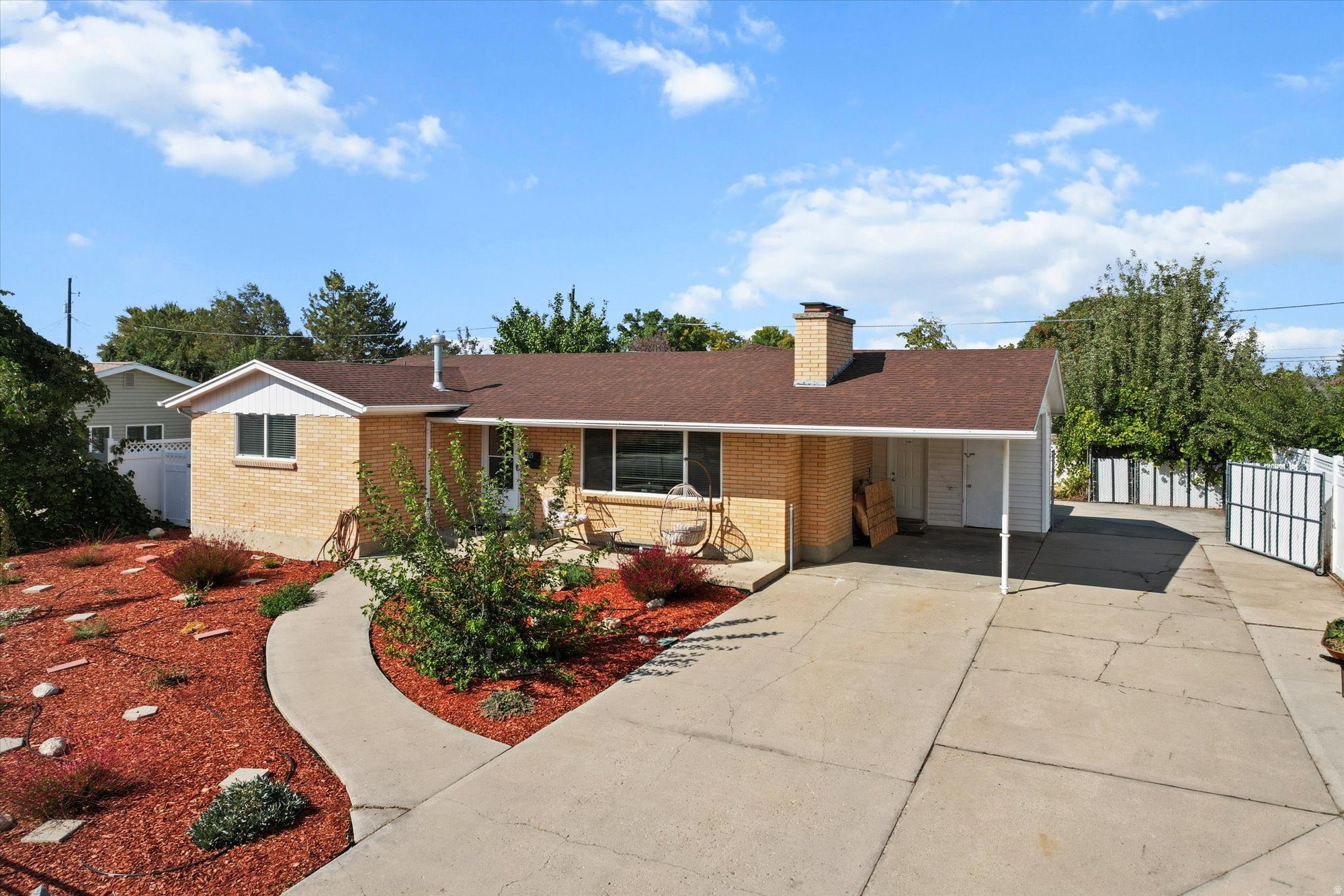 Beautifully updated brick rambler in Midvale offering 5 bedrooms, including a spacious primary suite with cozy fireplace. This move-in-ready home features a updated kitchen, fresh interior paint, new LVP flooring, and brand-new carpet throughout, delivering a clean and modern feel.  Situated on a desirable south-facing lot, the property includes a long RV pad, fully fenced front yard, and low-maintenance landscaping-ideal for convenience and outdoor enjoyment. Additional upgrades include updated vinyl windows, a reverse osmosis water system, and all appliances included.  Enjoy added peace of mind with a newer architectural shingle roof (installed in 2020). Separate back entrance with stair access presents potential for ADU or multi-generational living (buyer to verify). Laundry room can be coverted to a kitchen and opened up by removing a wall. Conveniently located minutes from I-15, shopping, dining, and Fashion Place Mall, this home offers both comfort and accessibility.  Information provided as a courtesy; buyer to verify all information.