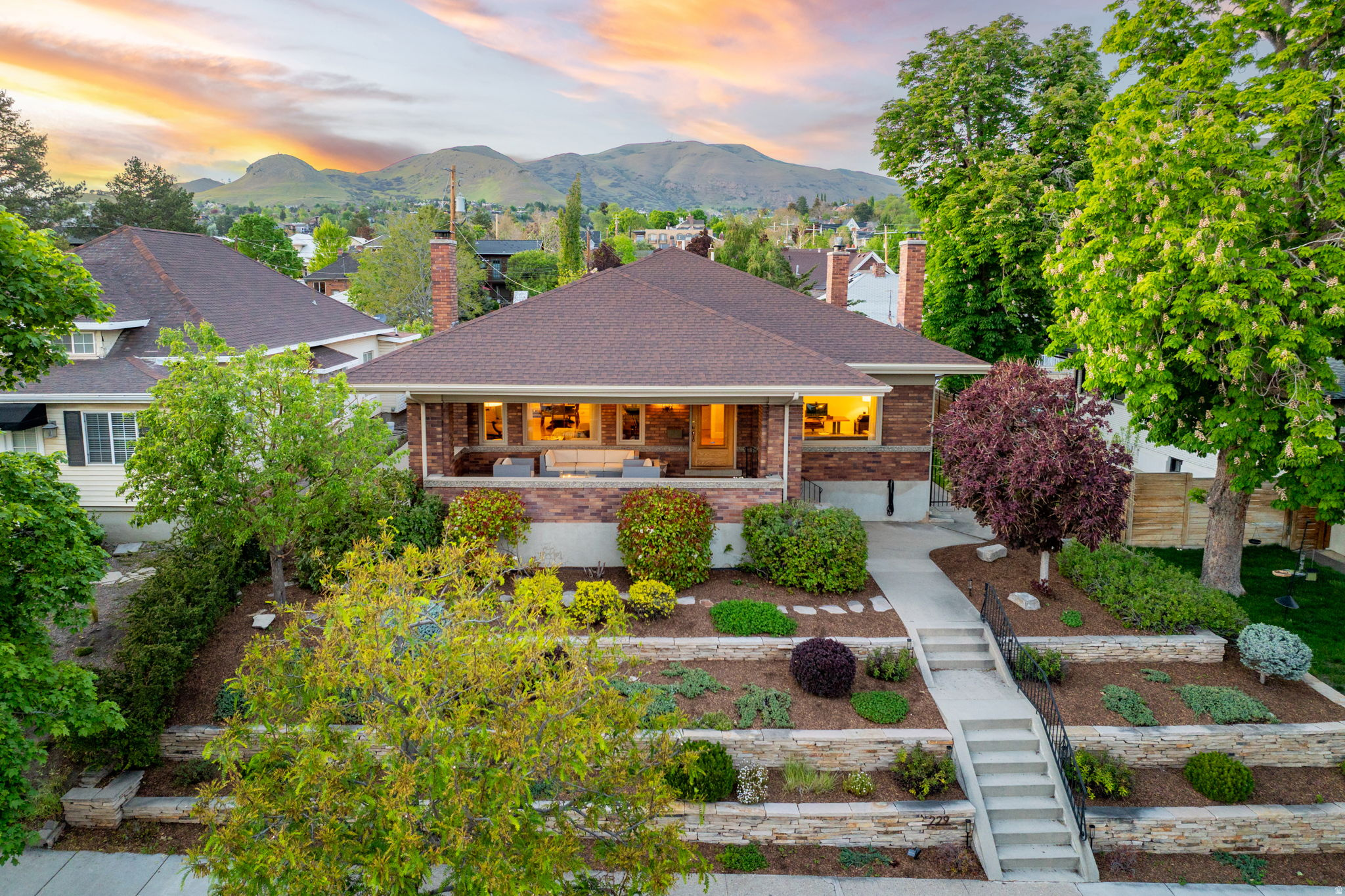 Where the City Twinkles and the Canyon Calls Perched in the storied Avenues of Salt Lake City, this 4,664-square-foot Arts & Crafts brick bungalow is a rare love letter to a neighborhood where character is currency. Step through the front door and the entire Salt Lake Valley unfurls before you - a glittering tapestry of city lights by night, framed mountains by day. What makes this address truly extraordinary is what lies just beyond it. Stroll downhill into the heart of the city for artisan coffee, celebrated restaurants, and downtown energy - then turn the other direction and find yourself walking straight into City Creek Canyon, one of the country's most beloved urban escapes for hiking and quiet immersion in nature. This duality - cosmopolitan and wild, refined and rooted - is the soul of the home. Inside, original 1920 hardwood floors glow with the patina only a century of careful stewardship can bestow, and much of the original door hardware remains - the kind of authentic craftsmanship that simply cannot be replicated. Five bedrooms, three bathrooms, and generous storage throughout offer space to live grandly and entertain effortlessly. The fully reimagined basement, brand-new HVAC system, and freshly fenced yard bring modern luxury and peace of mind to a home built to last another hundred years. And then there is the front porch - three times the size of any neighbor's - an invitation to linger, to host, to watch the valley shimmer awake each morning and settle into gold each evening. Homes like this don't come to market. They are passed down, whispered about, waited for. Yours, perhaps, has finally arrived.