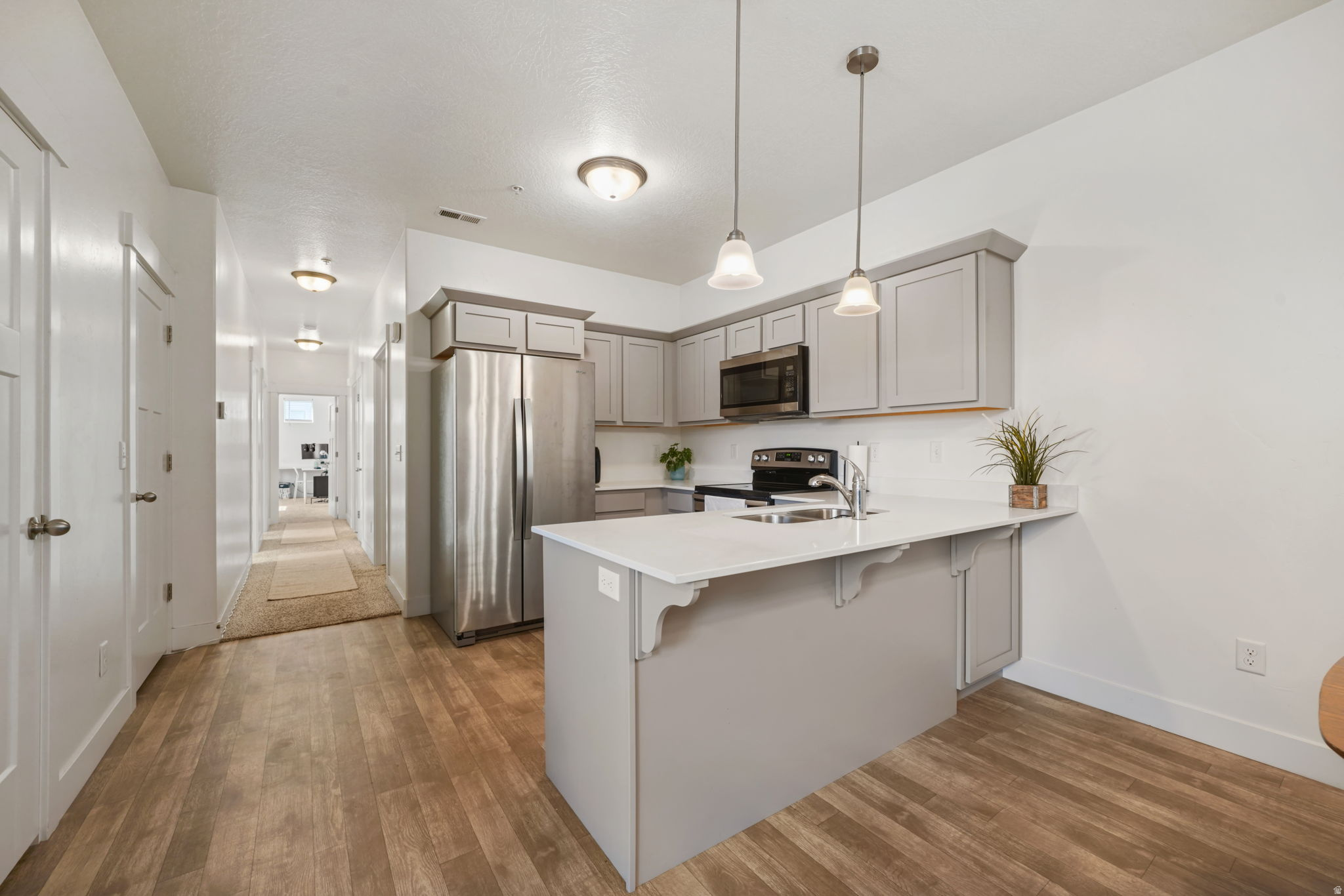**PRICE IMPROVEMENT** Experience effortless, single-level living in this well-designed middle-floor condo. The open-concept layout creates a natural flow from the kitchen, complete with sleek quartz countertops, into the dining and living spaces, making it ideal for both everyday living and entertaining. The spacious primary suite features a private bathroom and walk-in closet, while in-unit laundry and generous storage add to the home's practicality. Located just minutes from parks, scenic walking trails, and everyday essentials, you'll also love the close proximity to shopping and dining near Bellas Market, plus all the exciting amenities and conveniences found throughout Utah County. With easy access to I-15 and nearby FrontRunner stations, commuting is simple and efficient. As Vineyard continues to grow and develop, this property offers not only a comfortable place to call home but also a strong investment opportunity. Square footage figures are provided as a courtesy estimate from prior MLS data. Buyers are advised to obtain an independent measurement.
