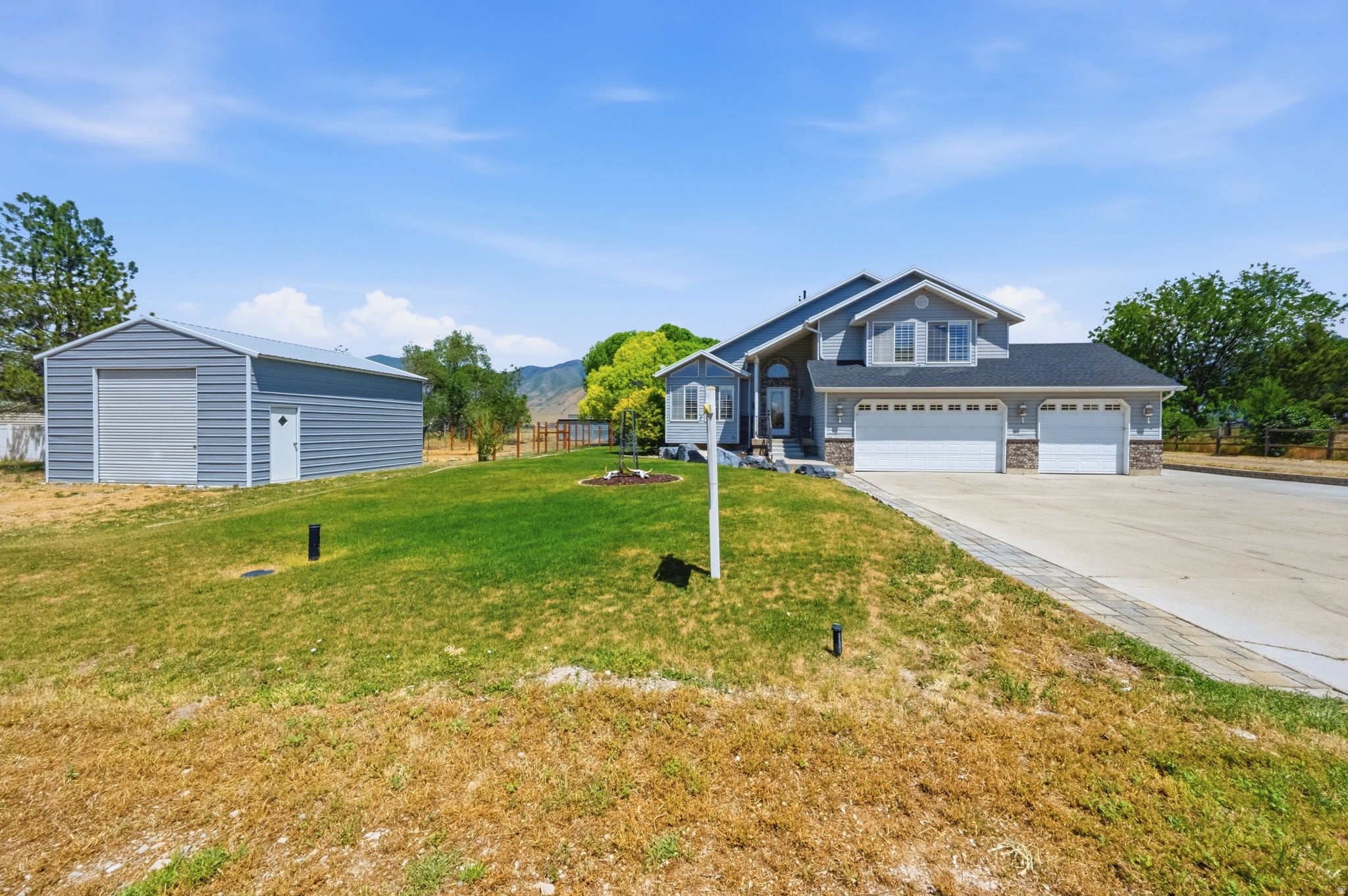 Rare unrestricted 1.45-acre Erda horse property - NO HOA, no neighbors crowding in, just true rural freedom minutes from town & 40 mins to Salt Lake. Built for horses from day one: a massive 7-stall metal barn & tack room, with power, lights & water spigots conveniently inside the oversized center breezeway & plumbed to individual stalls - making daily watering, chores & cleanup a breeze. Drive straight through the center breezeway for direct pasture access on both sides - horse life made easy. Add a separate hay barn, two large storage sheds & a horse walker, what else could you need?  The home itself has been thoughtfully updated too: remodeled kitchen, shiplap walls, new floors, fresh paint, plantation shutters, LED lighting, updated hardware, light-fixtures & fans throughout. The primary ensuite rocks a clawfoot tub & walk-in closet. Out front, the 3-car garage is great - but don't miss the bonus oversized 4th tall-bay, perfect for trucks, tall RVs, toys, tractors, or shop space. Fresh curb appeal welcomes you home. Whether you're bringing horses, livestock, or just craving room to breathe, this is what rural freedom looks like. Buyer to verify all.