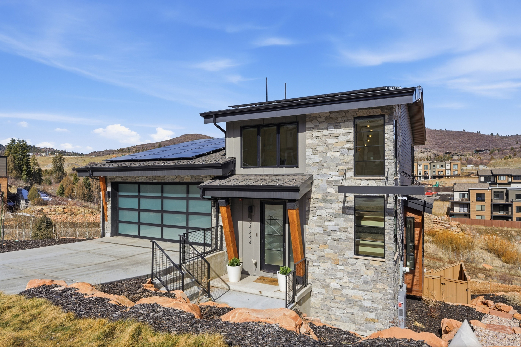 Discover the perfect fusion of sustainable living and high-alpine luxury in this meticulously maintained 3-bedroom, 2.5-bathroom residence. Situated within the premier Discovery Ridge enclave, this development borders 1,000 acres of protected open space, offering a true "backdoor-to-backcountry" lifestyle.  Designed for the modern mountain enthusiast, the property features a high-efficiency Solar Panel system and a Heated Driveway for effortless winter mornings. The thoughtfully Xeriscaped landscape honors the natural Utah terrain, while the private Hot Tub serves as the ultimate sanctuary after a day on the slopes.  Experience unparalleled recreation with immediate access to the Toll Canyon trail system for hiking, mountain biking, and snowshoeing right from your backyard. For year-round action sports, the world-class Woodward Resort is just moments away. Perfectly positioned for the frequent traveler, you are only 25 minutes from SLC International Airport and 20 minutes from the historic charm of Main Street Park City.