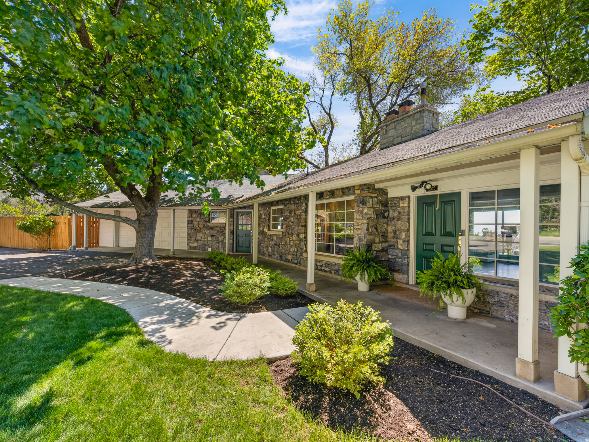 One-of-a-kind Oak Hills property offering spectacular, unobstructed views of Utah Valley, Utah Lake, and Rock Canyon. This rare home comes on the market once in a lifetime and is ideally situated on a large corner lot with a flat driveway and usable yard. Fully remodeled with high-end designer finishes, the home features custom solid wood inset cabinetry, new Pella wood-clad/aluminum windows, fresh Benjamin Moore Scuff-X paint, Emtek hardware, suspended slab concrete subfloors, and commercial-quality construction throughout. Enjoy a curb-less entry from the two-car garage for added convenience. The fully fenced yard is a true retreat with mature landscaping, fruit trees (peach, plum, pear, apricot), an herb garden, large garden beds, blackberry bushes, and a chicken coop. Walking distance to Rock Canyon Trailhead, Rock Canyon Park, and Rock Canyon Temple, this property offers unmatched location, craftsmanship, and lifestyle. A private mountain-view property 15 minutes from world-class skiing and 5 minutes to BYU.