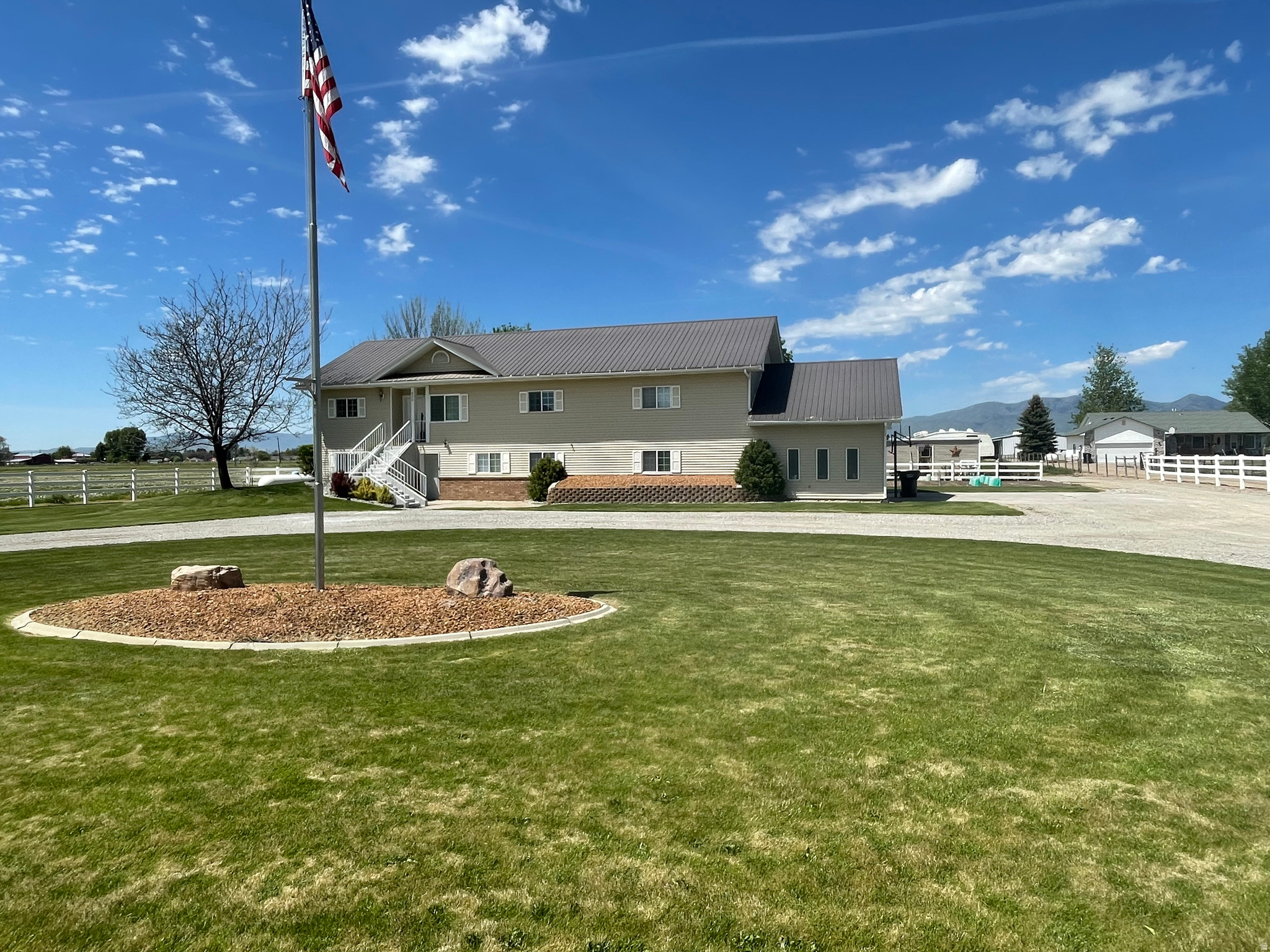 Welcome to your peaceful rural  retreat!  This impressive 3750 sq ft custom-built metal frame home with 8' concrete basement walls offers exceptional strength and longevity, exceptionally well-insulated to keep utility costs low and provide year-round comfort-no matter the weather.  Inside, the thoughtful layout delivers plenty of room with natural light and  features dual kitchens, 5 bedrooms, 2 1/2 baths, formal dining room, main floor laundry.   Main kitchen has an oversized island and newer appliances with plenty of room for family gatherings and  lots of cabinet and counter space.  Walkout basement has separate entrance, perfect for separate apartment, short term rental or mother-in-law suite with all new appliance and washer and dryer.  Pellet stove in the downstairs family room for extra cozy warmth.  Walk outside to the swing set, trampoline, garden space, 2 storage sheds, apple, peach, pear and apricot  trees, raspberry, blackberry and blueberry  plants.  Mature  shade trees and fruit trees grace this nearly acre lot. Circular drive way with plenty of parking, basketball hoop, vinyl fencing.  Enjoy peaceful evenings sitting around the firepit. Call for your private tour.