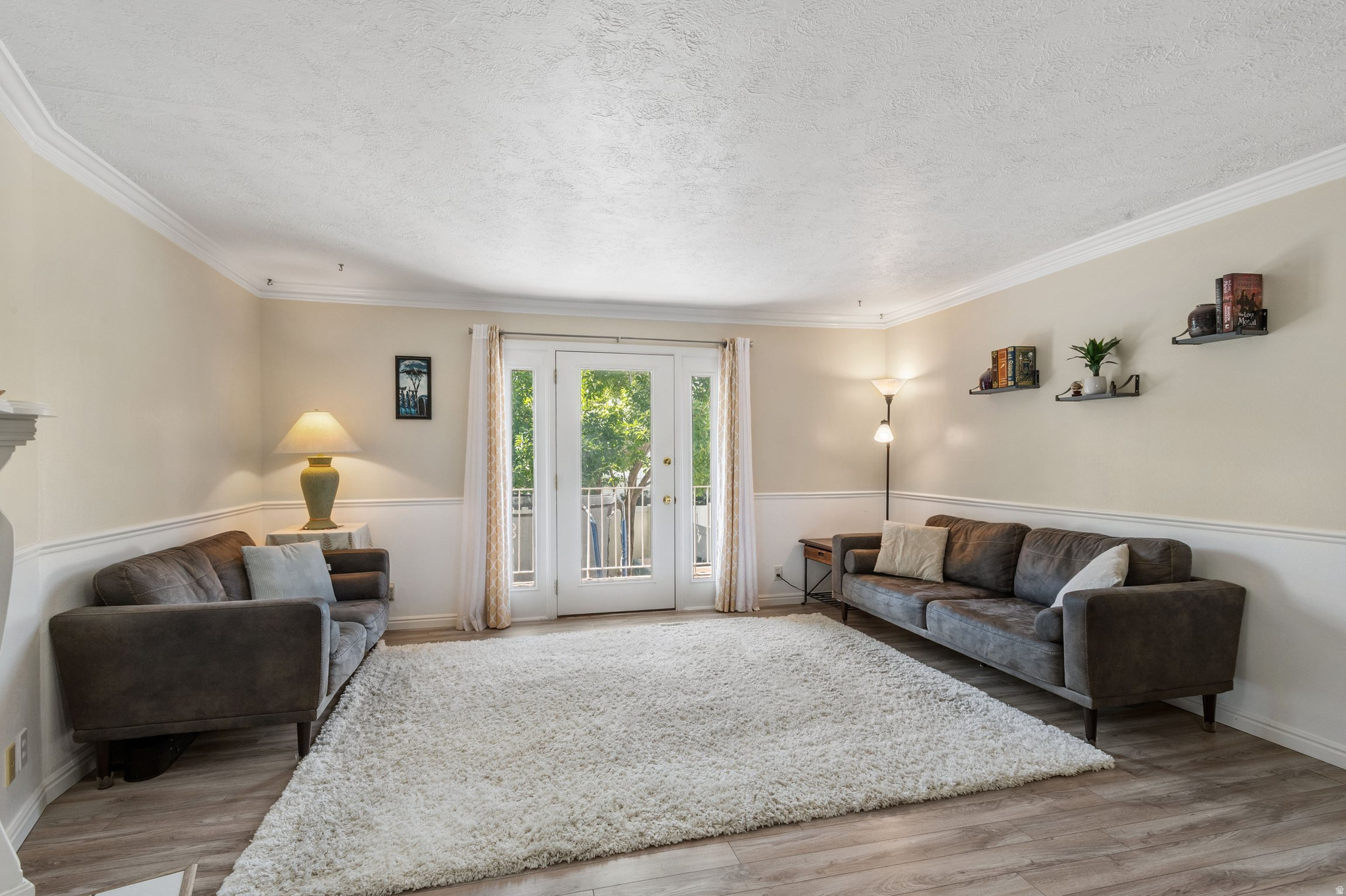 Experience the perfect blend of space and lifestyle in this spacious 1,888 sq. ft. Meadowbrook Estates townhome, ideally situated in a prime Bountiful location just steps from the elementary school and directly across from the South Davis Rec Center. The light-filled main level features a seamless open-concept great room anchored by a decorative fireplace, with elegant French doors opening to a private balcony that overlooks a large, fenced backyard. Modern LVP flooring flows through the upper level, while the cozy lower level provides a secondary living area and a versatile den perfect for a home office. With two bedrooms and a full bath on each floor, the layout offers exceptional privacy and flexibility, including a walkout basement for effortless outdoor access. Modern upgrades provide peace of mind, including a 2022 water heater, 2025 water softener, 2026 swamp cooler and a newer dishwasher, while the detached garage and two additional parking spots-one right at your front door-ensure plenty of convenience. The all-inclusive HOA covers water, sewer, trash, gas and common area maintenance. This an incredible opportunity for low-maintenance living with easy I-15 access.