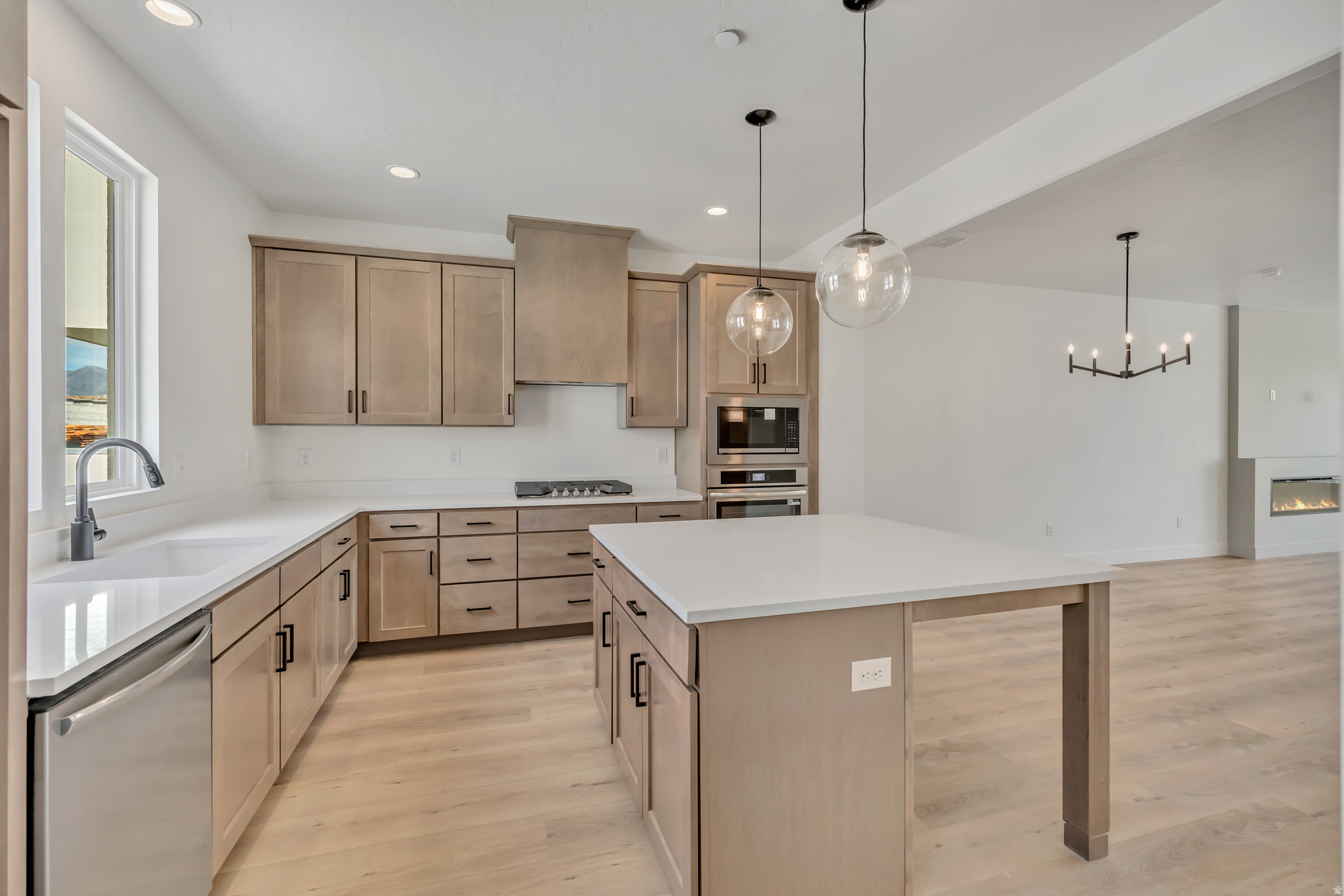 ** Living in Downtown Daybreak right near the Bees Stadium, Shops, Restaurants, & Year -Round Local Events! This Major League Model Brings Serious Upgrades: a Sleek Caf-Style Kitchen, Two Cozy Fireplaces (One in the Living Room, One in the Sky-room), & a Built-in Wet Bar for Elevated Entertaining. The Open Concept Floor Plan is Flooded with Natural Light, Creating an Easy Flow from Room to Room. Head up to the Sky-room and Rooftop Deck for Unbeatable Views, ready for your future Private Hot Tub! Whether You're Hosting or just Hanging out, this Home Brings it all: Style, Space, and the Best Location in the City! Move in Ready!! **Preferred Lender Incentive Offered, Ask Listing Agent for More Details!**
