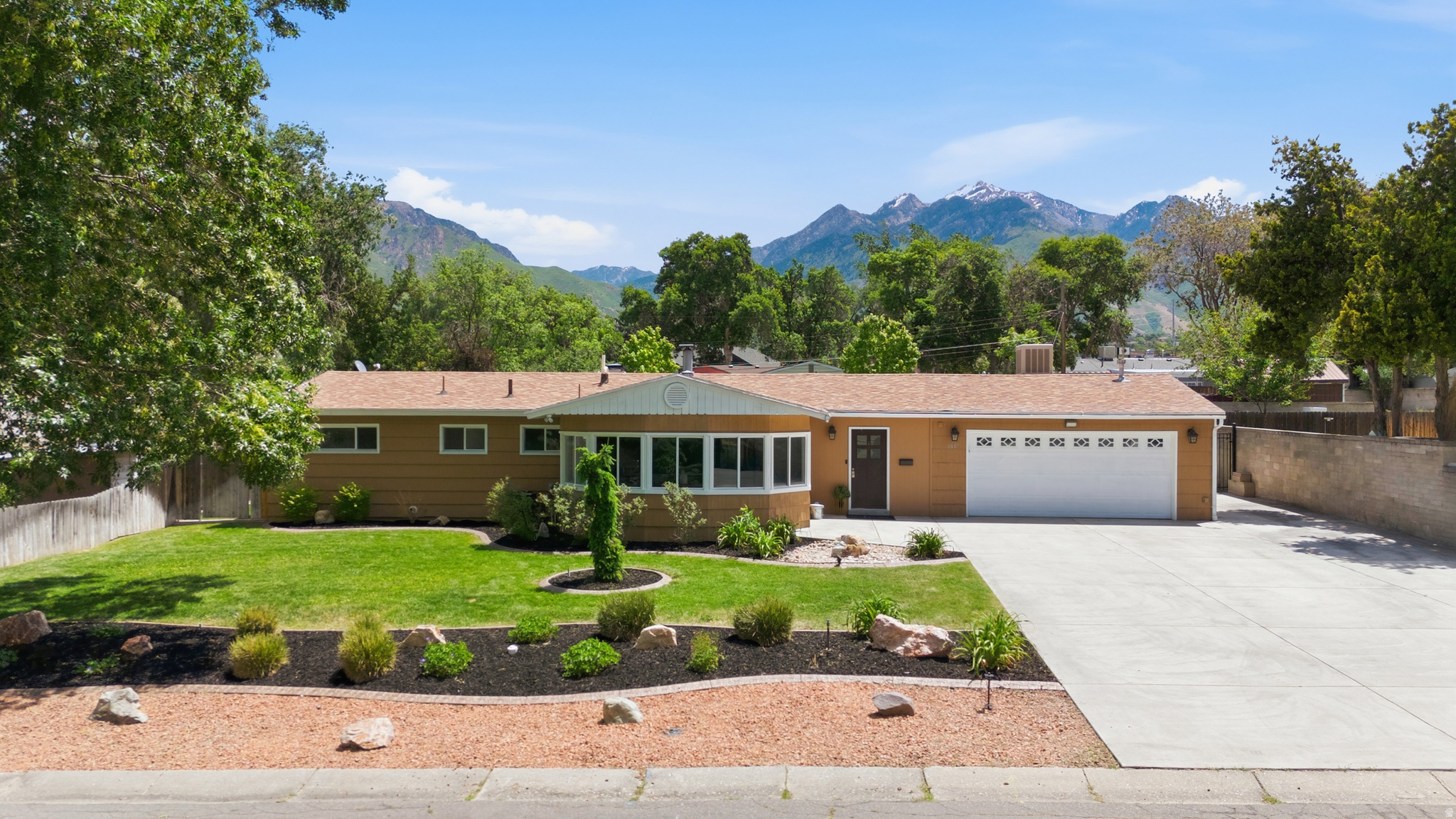 Welcome home to this beautifully updated single-level gem in Cottonwood Heights! This 3-bedroom, 2-full-bath home has been thoughtfully maintained and upgraded throughout - featuring fresh interior paint, stunning quartz countertops, and brand-new flooring. The open, easy single-level layout offers comfortable everyday living with no stairs to navigate. Step outside and discover your entertainer's paradise: a covered back patio, pergola, fire pit, and private hot tub - everything you need to relax or host in style. The .31-acre lot offers an expansive backyard with a large shed equipped with 50-amp power, ideal for a workshop, hobbies, or extra storage. RV parking adds even more versatility, with sewer clean-out. Car enthusiasts and EV owners will love the fully insulated garage with a dedicated 100-amp circuit for electric vehicle charging, plus its own swamp cooler and heater - a true year-round workspace. Located in the heart of Cottonwood Heights, this home checks every box. Don't miss it!
