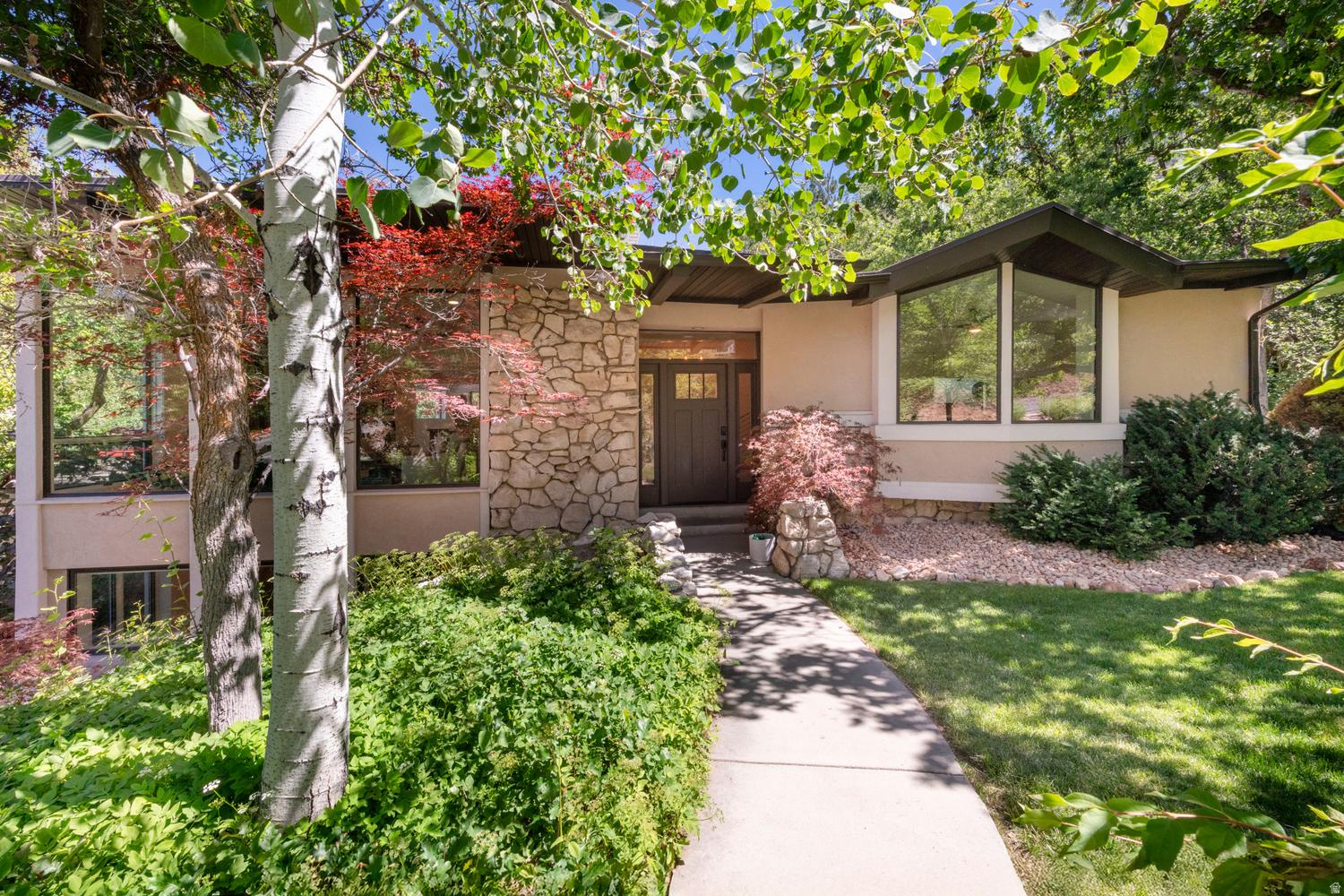 OPEN HOUSE SAT. JUNE 20 11-1 Must see this stunning  Olympus Cove residence. This amazing home has been redesigned by the renowned Doran Taylor Inc., blending contemporary style and natural beauty. Views of Mt. Olympus from your great room, deck, and bedroom/office. The Kitchen has all of the upgrades. Wolf wall oven, Induction range and hood, built in Dacor refrigerator and combination microwave/air fryer/convection oven. The hidden door offers a large Pantry with Laundry, and prep sink. The rooftop patio expands off of the kitchen, and offers beautiful Mountain and valley views. The Main Suite has a spa like bathroom, large walk in closet, and views, and sounds of the stream. Move down to the second kitchen space, additional laundry, and space for more entertaining. Two additional bedrooms, and walk out great room. Oversized four car garage, complete with your own dog was station, or perfect for washing all of your gear after your adventures. Solar panels for a lighter electric bill. Flagstone patio complete the home for outdoor relaxation and more views Must See!