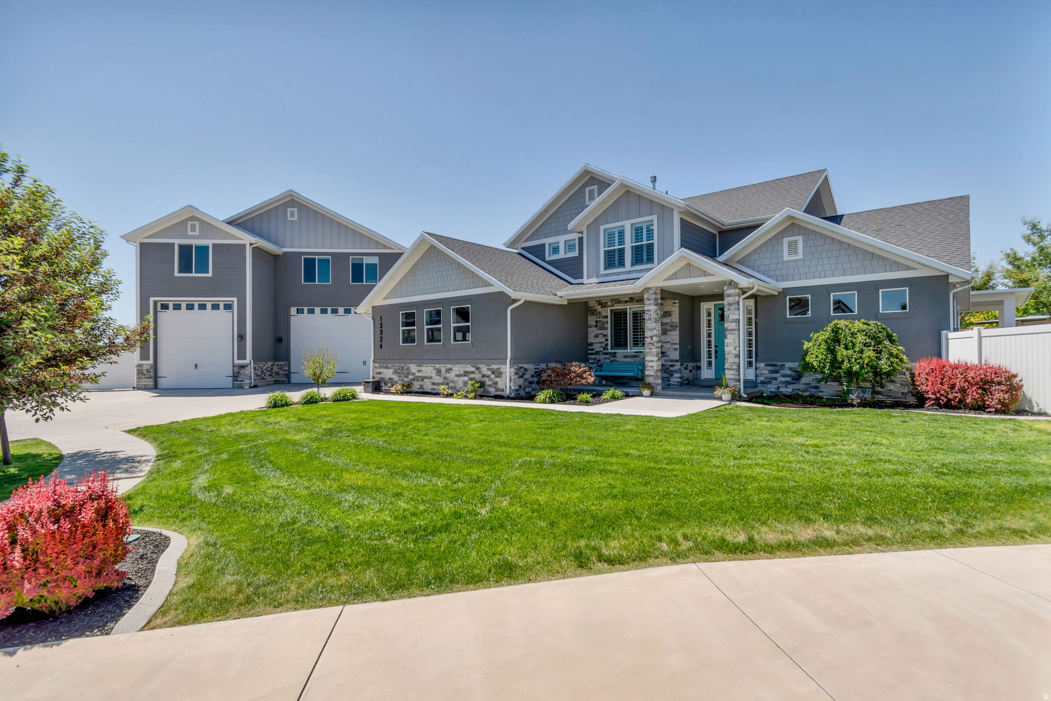 Here is your fantastic opportunity to own a beautiful custom home in one of Riverton's most sought-after neighborhoods! This home, built in 2018 with an effective year built of 2022, is located on a quiet cul-de-sac in the highly sought after Dansie Estates Subdivision. Situated on a .51-acre lot, this 6,755 square foot home offers 7 bedrooms and 6 bathrooms. 1,737 square feet of this livable space is located in the mother-in-law apartment above the large garage/shop. The home has an open floor plan and a layout that works well for both everyday living and entertaining. The main level features the primary suite, including double shower heads and a steamer in the full bathroom; along with a beautiful kitchen with custom cabinetry and granite countertops. Upstairs includes two bedrooms, a spacious loft area, and a full bathroom. The fully finished basement adds additional living space and features two more bedrooms, a laundry room, a full bathroom, a kitchenette, a family room, a newly remodeled theater, and a large cold storage room. Outside, the fully fenced (both decorative concrete and vinyl) yard offers plenty of space to enjoy the property, along with a large RV pad for additional parking. There is a fully automatic sprinkler system with secondary water. The home also features a heated driveway (via a gas boiler system), and 3 garages that accommodate up to 7 cars. Or the space can be used for boat storage, massive RV storage, or hobbies and/or workshop in this fully furnished shop, which is lined with customized metal paneling and rustic wood. There is also additional RV parking on the side of the tallest garage. The third-car garage is heated for parking a boat. There is 400-amp electrical service to the house, 200 of which goes to the largest, air-conditioned garage. There are four full HVAC systems for the house and garages. The outdoor covered patio provides additional space for relaxing or hosting gatherings with a plumbed outdoor kitchen area with beautiful granite countertops. Enjoy the heated gunite & plaster 18' x 42' salt system pool, which features a slide, a jumping platform, and a BADU swim jet system which is perfect for swimming laps, in addition to giving the pool a lazy river effect. Accompanying the pool is a changing room/pool house/bathroom and a 9 x 8 new Bullfrog Spa M9 Series hot tub that seats 10 people. The pool also has an electric cover. Also next to the pool is a lighted basketball & sports court and a zip line. The home also features permanent JellyFish year-round app-controlled exterior lighting.  There are 57 solar panels on the large garage's roof.