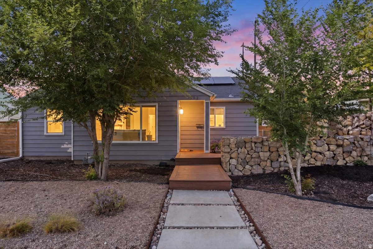 This home is truly going to knock your socks off! Beautifully updated from top to bottom, every detail was thoughtfully designed to create a space that feels both stylish and inviting. From the moment you pull up, the tastefully xeriscaped front yard sets the tone. As you approach the front door, the spacious front deck immediately catches your eye - and trust us, you'll be spending plenty of time there. Step inside and instantly feel at home. The bright and open living area is filled with natural light and highlighted by a stunning wood-paneled accent wall that adds warmth and character. The beautifully updated kitchen is a dream space for cooking and gathering, featuring gorgeous cabinetry, stainless steel appliances, open shelving, and large windows that make the entire room feel airy and welcoming. The open-concept layout keeps everyone connected, making entertaining effortless. The primary suite offers a beautifully designed en suite bathroom that perfectly blends style and functionality. Downstairs, the spacious family room creates the ultimate hangout space with a built-in bar, room for a game table, and plenty of space for cozy movie nights or entertaining guests. The basement also features an additional gorgeous bathroom and an oversized bedroom. And now, back to that deck... This outdoor oasis was designed for relaxing and entertaining alike. Surrounded by fabulous rock walls that create both privacy and ambiance, it's the perfect setting for summer evenings with friends and family. Gather around the firepit for s'mores and conversations that last long into the night. Additional highlights include a garage with extra storage or workshop space, ample driveway parking, and fully paid-off solar panels that help keep electric bills low. Located just minutes from downtown Sugar House, shopping, dining, and entertainment, this home truly checks every box - and then some!
