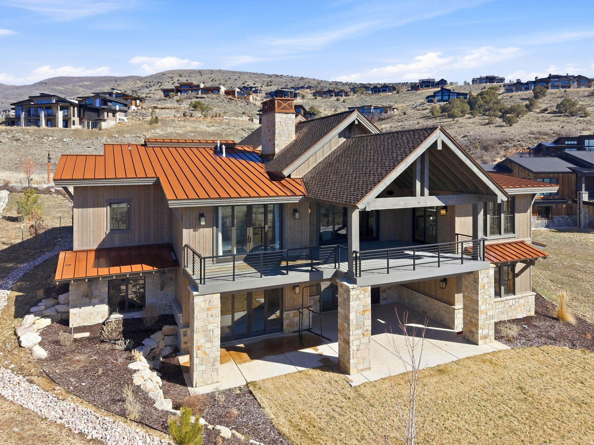 Nestled within the prestigious Red Ledges community, this exceptional custom home delivers commanding views of the Heber Valley and Mt. Timpanogos from nearly every room. At 6,530 square feet, the open floor plan balances grand scale with warmth, anchored by large windows that frame the mountain landscape and fill the home with natural light. The gourmet kitchen features top-of-the-line stainless steel appliances, custom cabinetry, and a generous center island - ideal for entertaining. A main-level primary suite, luxurious finishes throughout, and an oversized 3-car garage round out a home built for the Utah mountain lifestyle. The stone and wood exterior blends naturally into the Red Ledges setting, and the 0.54-acre lot provides privacy and space rarely found at this elevation.