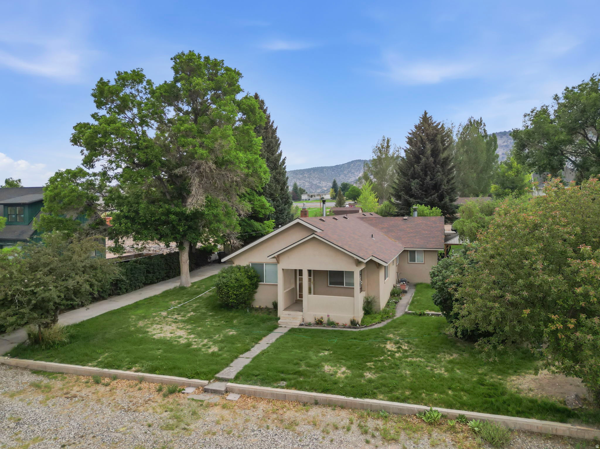 Welcome to this charming single-level home in the heart of Bicknell, Utah! Situated on 1.12 acres comprised of two separate parcels, this property offers options that are hard to find. Enjoy the extra space and privacy, build another home, or explore selling the additional lot in the future.  Inside, you'll love the comfortable, functional layout featuring a spacious primary bedroom with a large walk-in closet. Outside, the oversized covered carport provides plenty of room for vehicles, trailers, or recreational toys, while two storage sheds offer even more space for tools and equipment. The property also includes 2.4 shares of irrigation water. Located just minutes from Capitol Reef National Park, Boulder Mountain, world-class fishing, ATV trails, hiking, and endless outdoor recreation, this home is perfectly suited as a primary residence, retirement home, or weekend getaway.