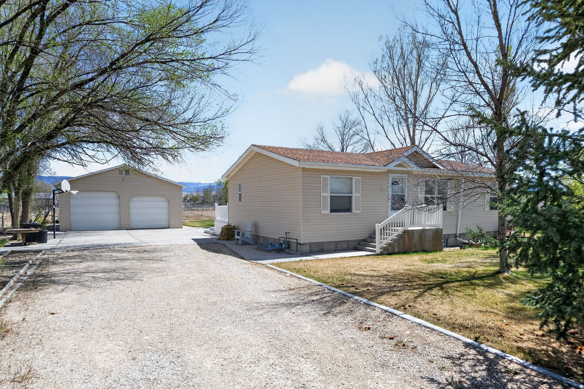 Use our preferred lender and get a 1-0 INTEREST RATE BUYDOWN at no cost! BRING YOUR HORSES!!! 1.14 ACRES!!! Discover peaceful country living in this SPACIOUS 5-bedroom, 3-bath rambler in quiet Centerfield, just minutes from Gunnison. Enjoy MAIN-FLOOR living, two large family rooms, and an OVERSIZED 2 car GARAGE plus a 450 SQUARE FOOT SHOP! Enjoy peace of mind with NEWER ROOF, AC, and FURNACE! Relax under towering shade trees, watch glowing sunsets, enjoy horse-friendly pasture, and relish true country living.