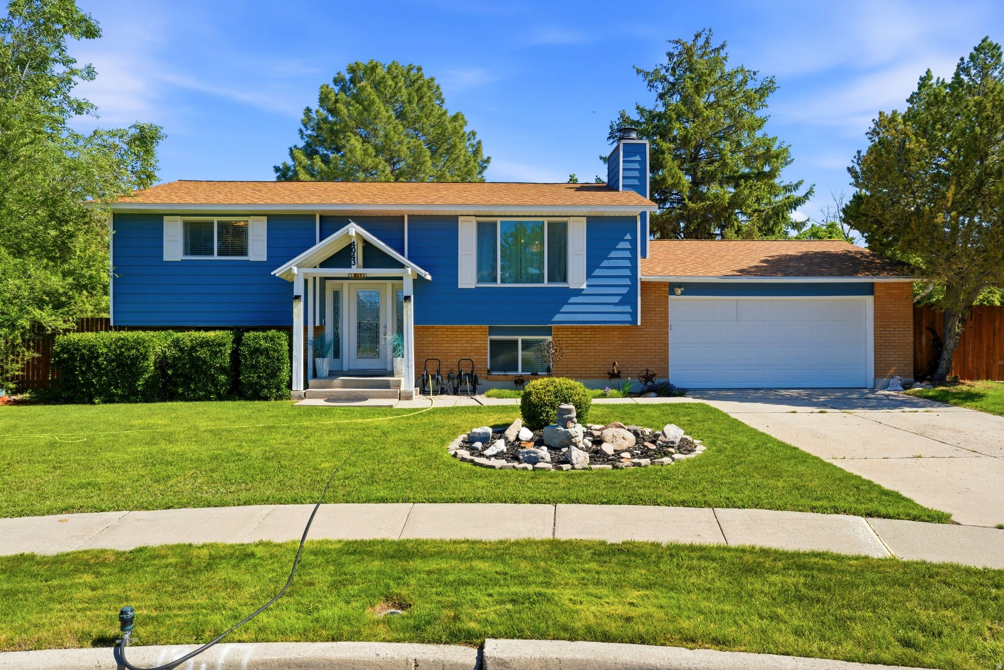 Welcome home to this beautifully maintained split-level home offering the perfect blend of comfort, functionality, and outdoor living! Situated on a generous lot with mature trees and a fully fenced backyard, this 3-bedroom, 2-bath home has something for everyone. Enjoy cooking in the updated kitchen with modern appliances, ample cabinet space, and a bright window overlooking the backyard. The cozy living room features a stone fireplace, perfect for relaxing evenings. Downstairs, the finished basement offers a versatile rec room-ideal for entertaining, a home gym, or game nights. Step outside to your private backyard retreat with a large deck, shade sails, and a hot tub-perfect for gatherings or quiet relaxation. There's plenty of room to play, garden, or simply enjoy the peaceful surroundings. A variety of beautiful birds love this backyard oasis!  Conveniently located near schools, parks, shopping, and dining with easy access to everything you need! Square footage figures are provided as a courtesy estimate only and were obtained from County Records.  Buyer is advised to obtain an independent measurement.