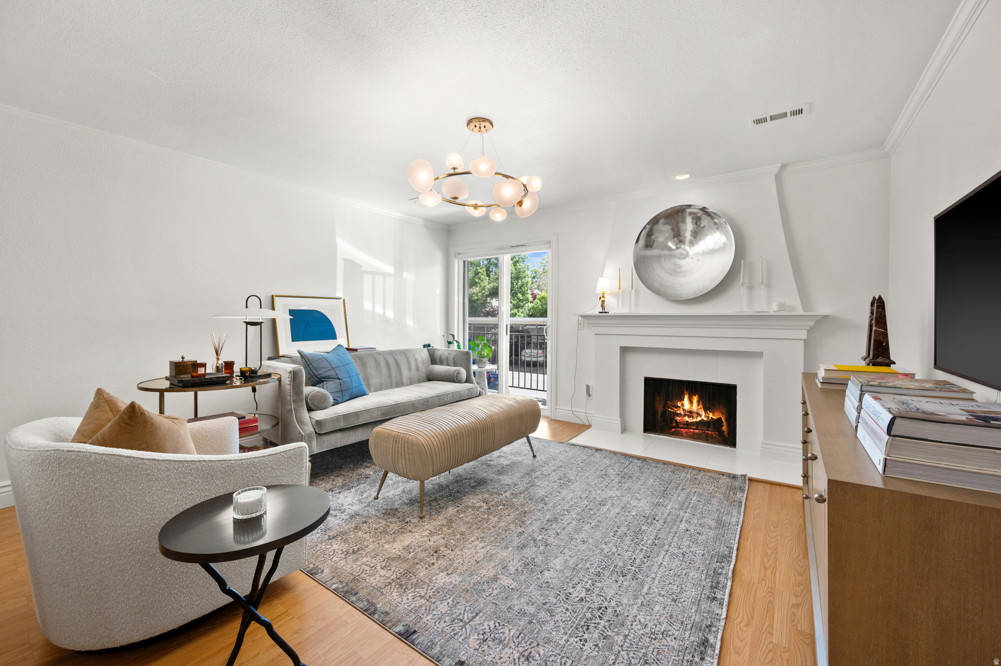 SUMMER'S BEST ACCESSORY: GOOD TASTE. There are homes with "designer finishes," and then there are homes personally curated by the designer-owner herself, who also happens to design furniture for one of Utah's most prominent luxury furniture brands. Flooded with natural light, this condo rarely requires overhead lighting, making the stunning designer light fixtures throughout feel even more artful and inviting. Features include in-unit laundry, wood-burning fireplace, balcony access from both the living room and the primary suite, walk-in closet, massive pantry, and gas range. Better yet, the only utility bill you pay is electric! Community amenities include a sparkling pool, clubhouse, fitness room, cable TV, gas, water, sewer, garbage, exterior maintenance, snow removal, and insurance. One covered parking space included, plus abundant guest parking nearby. Summer begins here at Creekside!