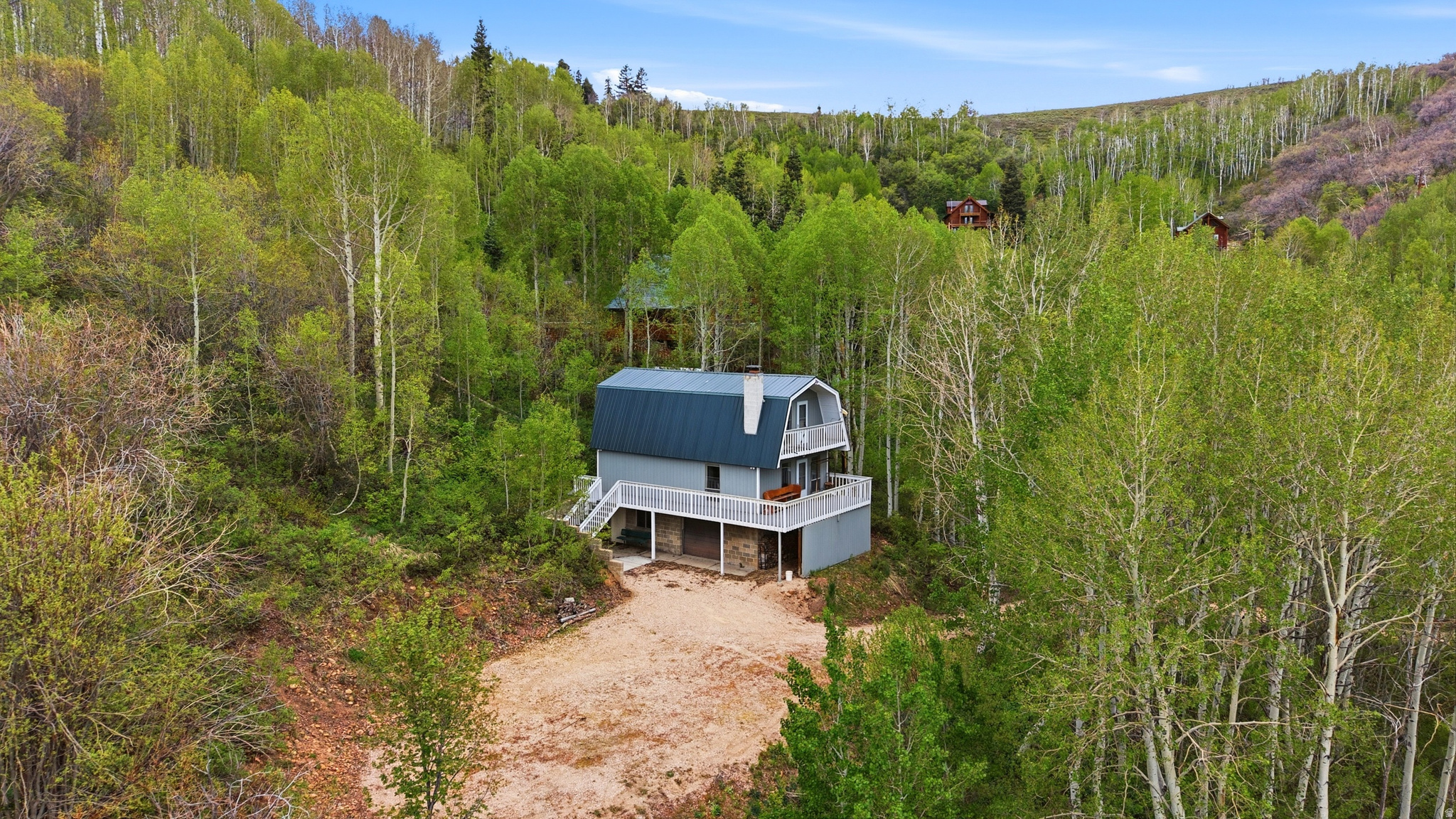 Welcome to this 1980 A-frame cabin in Causey Estates, on 2.12 acres this 1,664 sq ft cabin is one you won't want to miss. Great for creating memories with family and friends or for a quiet private getaway. The main level features 1 bedroom and a full bath, with an open kitchen, living room, and dining area anchored by a wood-burning fireplace. Vaulted ceilings open into a loft with a second bedroom and multiple sleeping areas for guests. Sleeps nine or more. Electric furnace installed 2024. New metal roof installed in 2020. Outdoor living includes a wraparound deck and a balcony. An attached basement-level garage provides parking and extra storage. Floor drains in the basement.  Great as a vacation retreat or year-round escape with room to personalize. Make this cabin your very own!