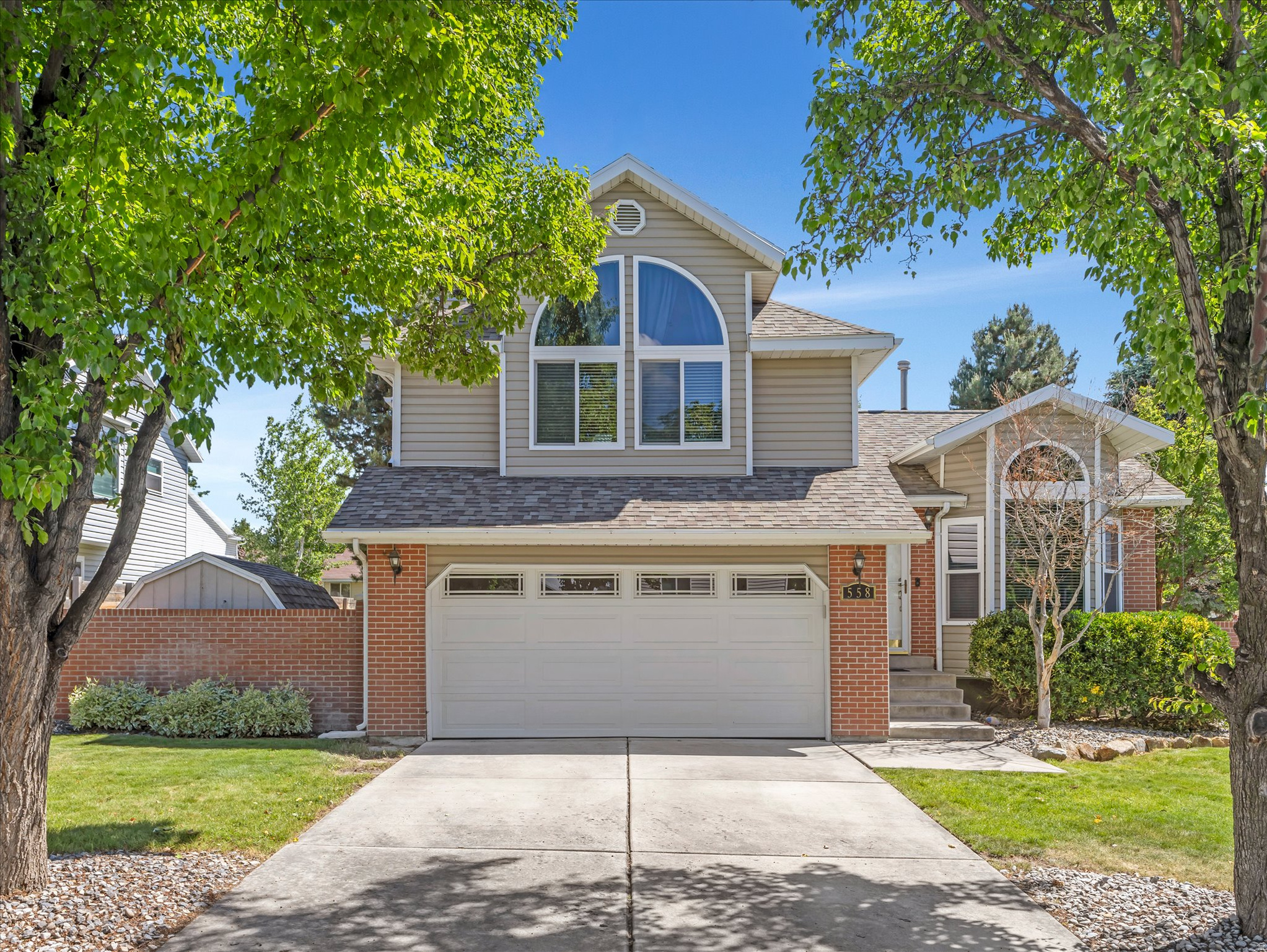 Tucked away on a quiet cul-de-sac in one of East Sandy's most sought after neighborhoods, this beautiful home offers the perfect balance of comfort, convenience, and outdoor adventure. Ideally located near top rated schools, parks, shopping, and quick access to both Big and Little Cottonwood Canyons for hiking, biking, and world-class skiing. Easy freeway access makes commuting anywhere in the valley a breeze. Step inside and be welcomed by soaring ceilings, fresh new paint, and stunning luxury vinyl flooring throughout the main level. Oversized brand new windows flood the home with natural light, creating a bright and inviting atmosphere throughout. The kitchen features crisp white cabinetry, stainless steel appliances, and a functional layout perfect for everyday living and entertaining. Recent appliance updates include a refrigerator (2022), dishwasher and microwave (2023), all included with the home. A spacious corner pantry provides excellent storage, while the spacious breakfast bar and adjacent dining area offer plenty of seating options. Just a few steps down, the cozy living room invites you to relax beside the stylish tile fireplace with white surround and mantel. From here, step outside to the trellis covered patio, the perfect space for barbecues, outdoor dining, or simply unwinding while enjoying the fully fenced backyard complete with an included playground. Upstairs, you'll find two spacious secondary bedrooms filled with natural light and a full bathroom. The generous owner's suite offers a peaceful retreat featuring a walk-in closet and an ensuite bath with double sinks, a separate soaking tub, and walk in shower. The lower level includes an ideal guest room with a built in trundle bed, a  bathroom, and a large laundry room with additional storage space. This home is truly move in ready with extensive recent upgrades, including: New roof (2020); New LVP flooring throughout main level (2023); New double-pane vinyl windows throughout (2023); New furnace, heat pump on the A/C system, and smart thermostat (2025); New water softener (2023); New garage door, opener, and upgraded electrical panel with 220V capability for EV charging or workshop use; New refrigerator (2022); New dishwasher and microwave (2023); New recessed kitchen lighting; Fresh paint on the main level. Every major update has already been completed. All that's left to do is move in and make it your own.