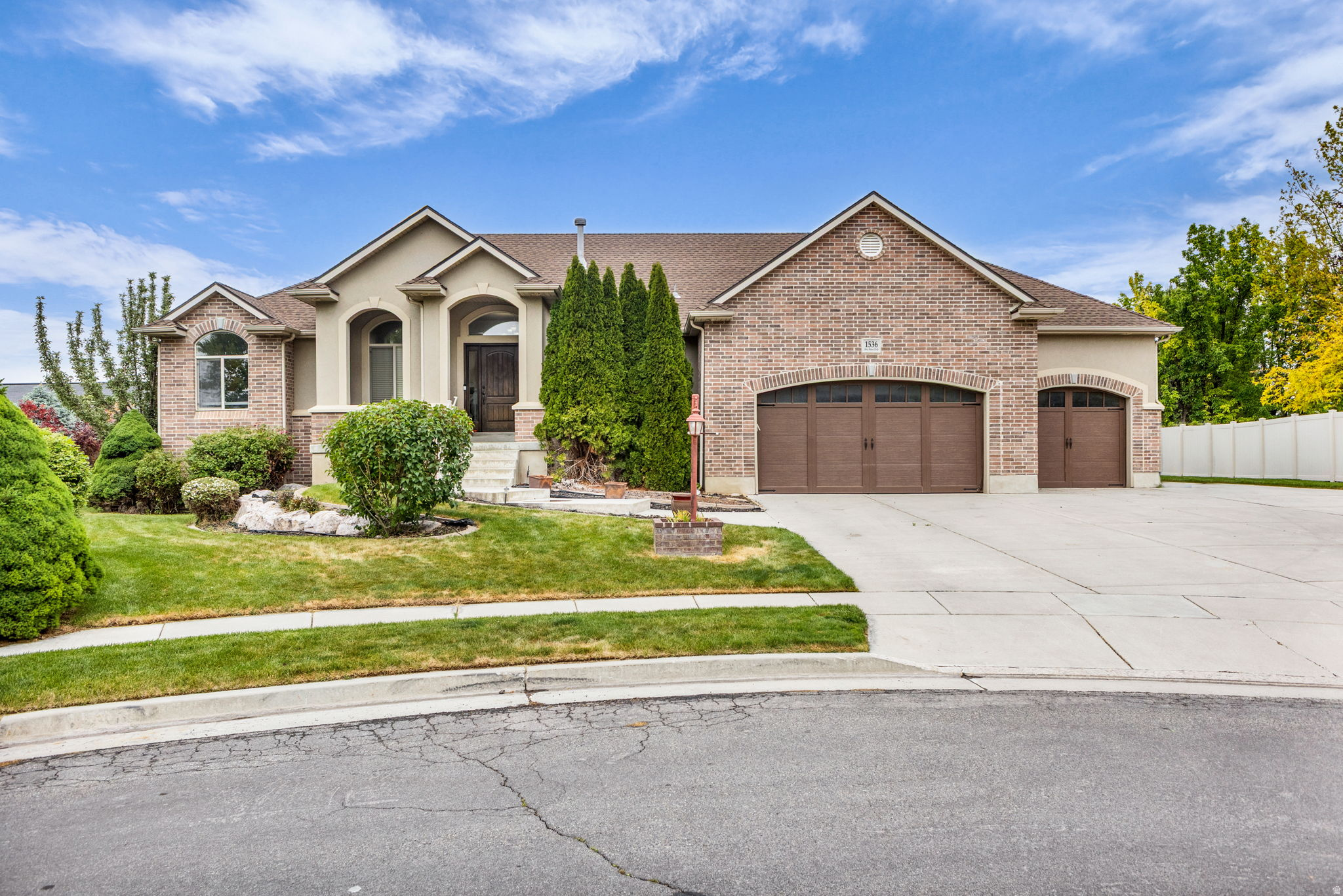 NEW PAINT - NEW CARPET - FRESH LANDSCAPING - CABINET PAINTING ALLOWANCE   Located at the end of a quiet cul-de-sac in the desirable Mountain Vista neighborhood, this spacious brick and stucco rambler offers nearly 3,600 sq ft with 6 bedrooms, 4 bathrooms, and a fully finished walkout basement. Vaulted ceilings and an open-concept layout create a bright, welcoming feel, while the gas fireplace and covered Trex deck make the home ideal for relaxing or entertaining.  The kitchen features abundant cabinetry and bar seating, while the main-level primary suite offers private backyard access and a large walk-in closet. Downstairs includes 3 additional bedrooms, generous storage, a pellet stove, and flexible living space.  Situated on a fully landscaped .32-acre lot with mountain views, RV parking, storage shed, and an oversized tandem 4-car garage with epoxy floors and built-in shelving. Conveniently located near parks, trails, shopping, freeway access, and TRAX.  Square footage figures are provided as a courtesy estimate only and were obtained from tax records .  Buyer is advised to obtain an independent measurement.