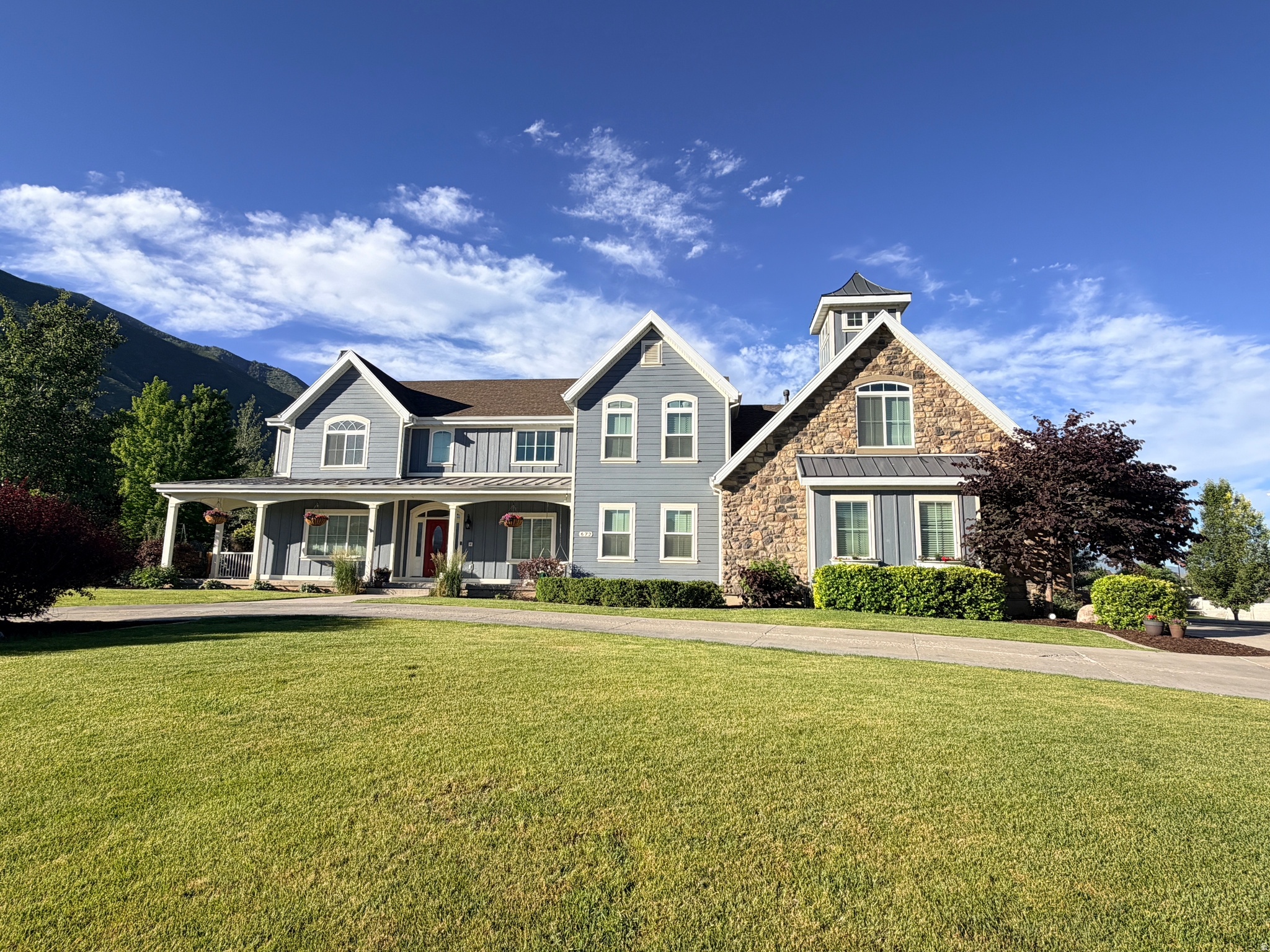A rare opportunity...The 'Preserve at Mapleton' features  this unmatched combination of luxury, space, and versatility in this beautiful farmhouse with a wrap-around porch to boot!  Glorious Maple Mountain is your backdrop.  This neighborhood speaks for itself.  Perfect for multi-generational living with large rooms and soaring ceilings. All the bedrooms upstairs, secret rooms  and passageways here and there. Kids and adults alike will be enchanted and love to get lost here.  Car enthusiasts and hobbyists will love the gargantuous 8-car garage/shop/barn.  Provides RV parking with hookups, 13 feet of clearance, a whopping 41 feet of depth, extra height, a workbench, heat and shelving galore...and then there's more! Workshop space or ADU potential upstairs or additional storage/workshop area. Owned solar panels (installed  2014 & 2021) keep energy costs in check. Outside, two decks and a covered patio invite you to soak in the scenery, surrounded by mature trees, fruit trees garden boxes, gazebo--fit with pizza oven and fire pit, and kids splash pad and water feature too. Wait...DID I MENTION? there is a basketball court and climbing wall and personal gym in the basement. BACKUP GENERATOR INCLUDED. This home has it all!  Showings will start June 27. Offers due by July 8, 2026---OPEN HOUSE: JUNE  27, 9-11 am