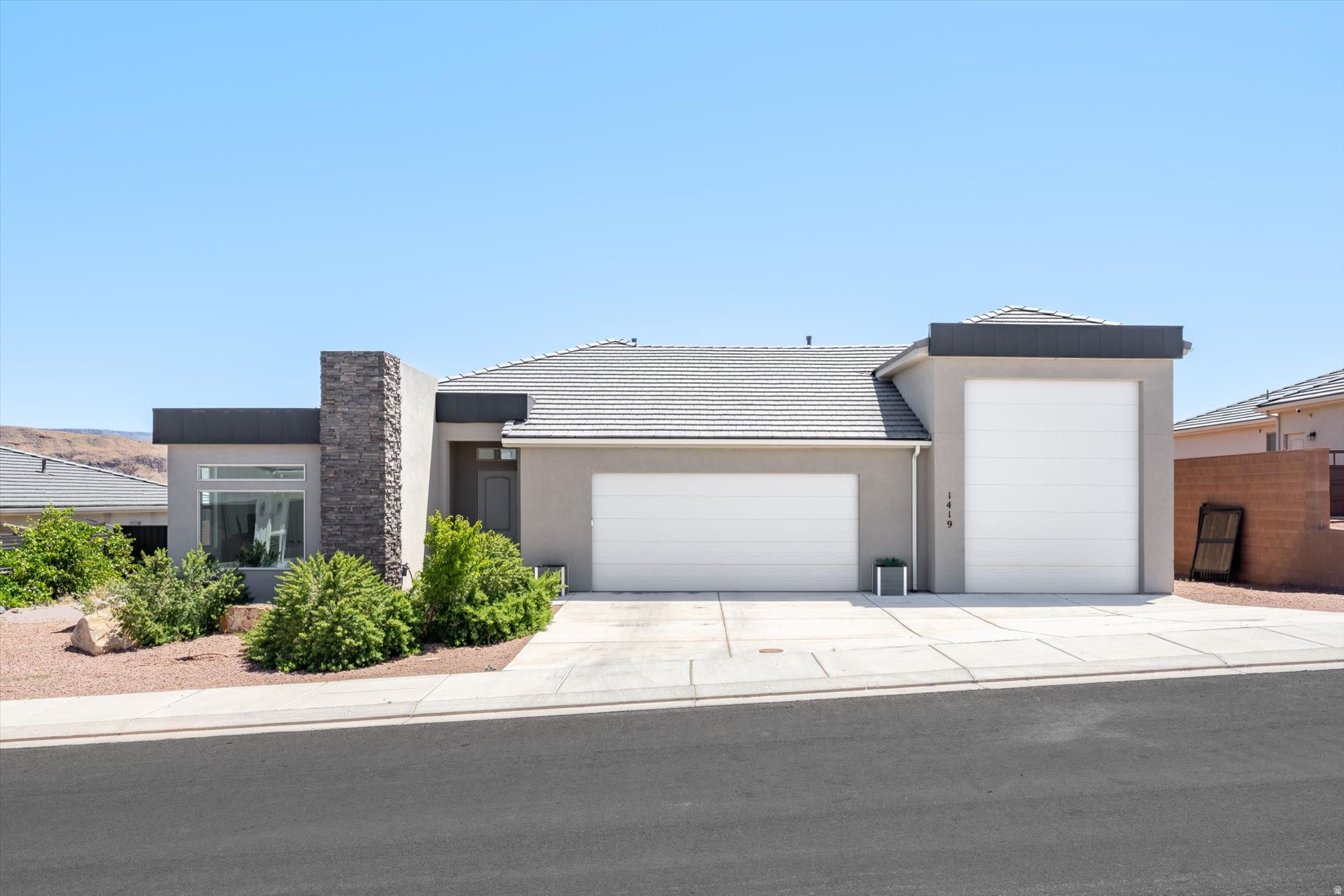 Modern design, breathtaking views, and an incredible RV garage come together in this beautifully maintained Painted Sands home in Hurricane. Designed with both comfort and functionality in mind, this home features an open-concept layout filled with natural light, soaring ceilings, and oversized windows that frame the surrounding desert landscape. The spacious great room flows seamlessly into the kitchen and dining areas, creating an inviting space for entertaining or relaxing at home.  The kitchen offers quartz countertops, crisp white cabinetry, stainless steel appliances, a gas range, oversized island seating, walk-in pantry, and generous storage throughout. A dedicated office with custom built-ins provides the ideal work-from-home setup, while the thoughtfully designed laundry and mudroom spaces add everyday convenience.  The private primary suite feels like a retreat of its own with expansive picture windows, stunning mountain views, a spa-inspired en suite featuring dual vanities, a large walk-in tiled shower, and an impressive walk-in closet with abundant storage. Additional bedrooms are spacious and bright, offering flexibility for guests, hobbies, or additional workspace.  One of the standout features of this property is the massive RV garage with epoxy floors, oversized door clearance, exceptional depth, and ample room for vehicles, toys, storage, workshop space, or outdoor adventure gear. Outside, the covered patio and low-maintenance backyard create the perfect setting to enjoy Southern Utah sunsets and panoramic desert views year-round.  Located in the sought-after Painted Sands community, this home offers quick access to Sand Hollow Reservoir, golf, hiking, biking, ATV trails, and endless outdoor recreation while still being conveniently close to shopping, dining, and everyday amenities.