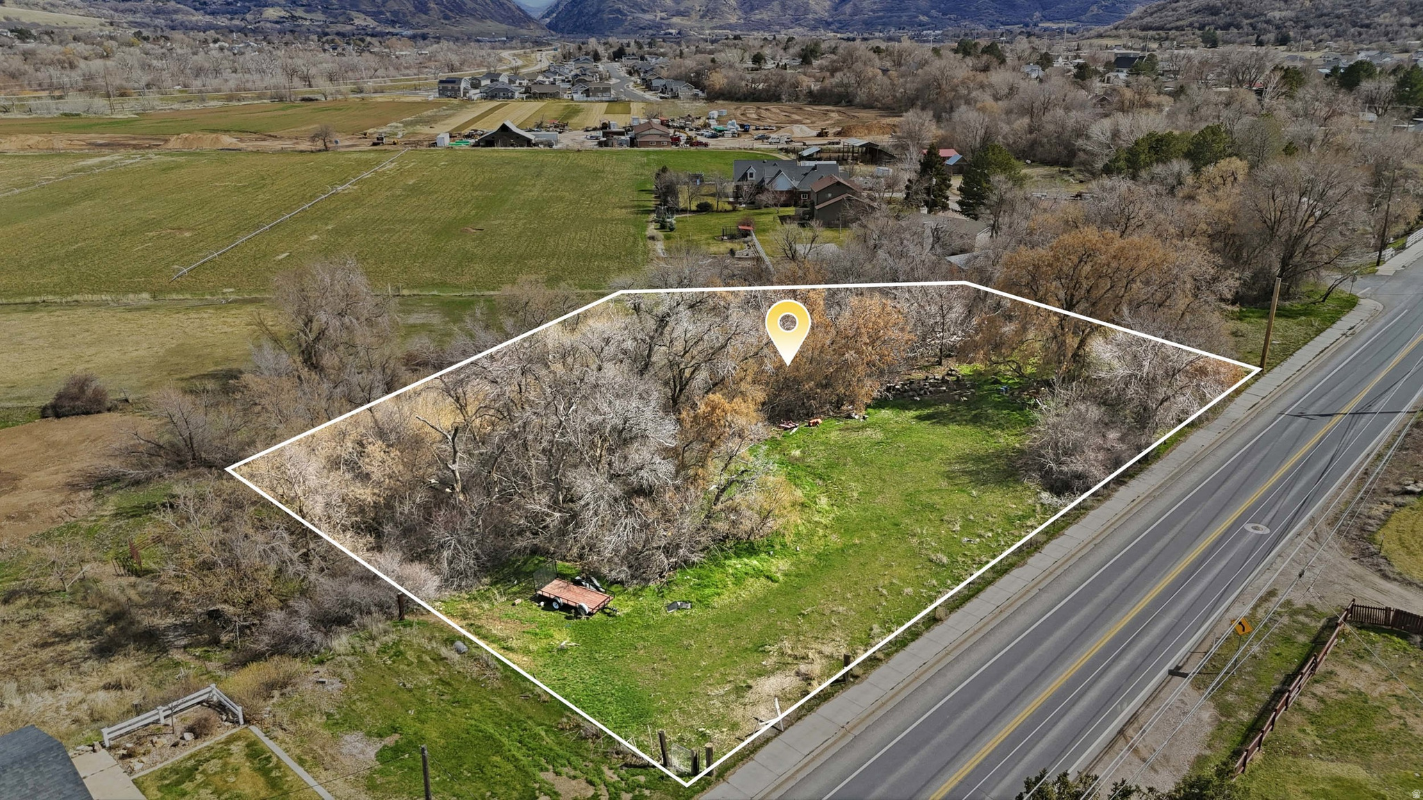 Great opportunity to own 1.9 acres in the highly desirable community of South Weber. Currently taxed under the Greenbelt with no improvements on property. Beautiful views and plenty of space to make this attractive option for those looking to build or hold land as an investment. According to the city's future land use map, the area is identified as Low Density Residential (buyer to verify zoning and development potential with city). Buyer to verify utilities, zoning, and building requirements. Rollback taxes may apply if the property is removed from the Greenbelt.