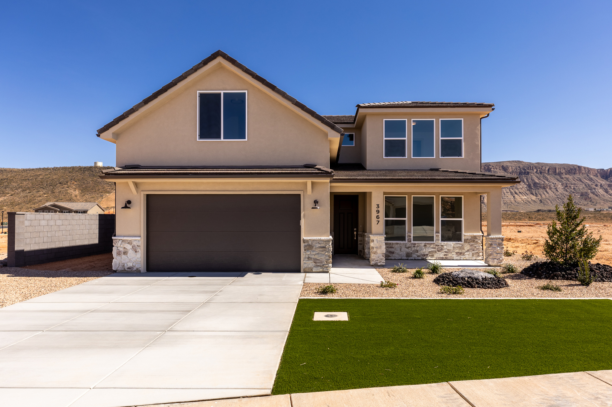 Stunning 5-bedroom home (primary on main) with office/den, RV/boat parking, and no rear neighbors. The lot spans from street to street, offering exceptional privacy and the flexibility to add a detached garage/ADU at the back or create a pull-through driveway. Solid construction with 2x6 exterior walls, block walls on both sides and across the back with gate access. Large backyard with covered patio and evening shade. 2-car garage deep enough for a truck or SUV. Quiet community perfect for families, just minutes to BLM land, Sand Hollow Reservoir, and golf. Includes 1-year builder warranty.