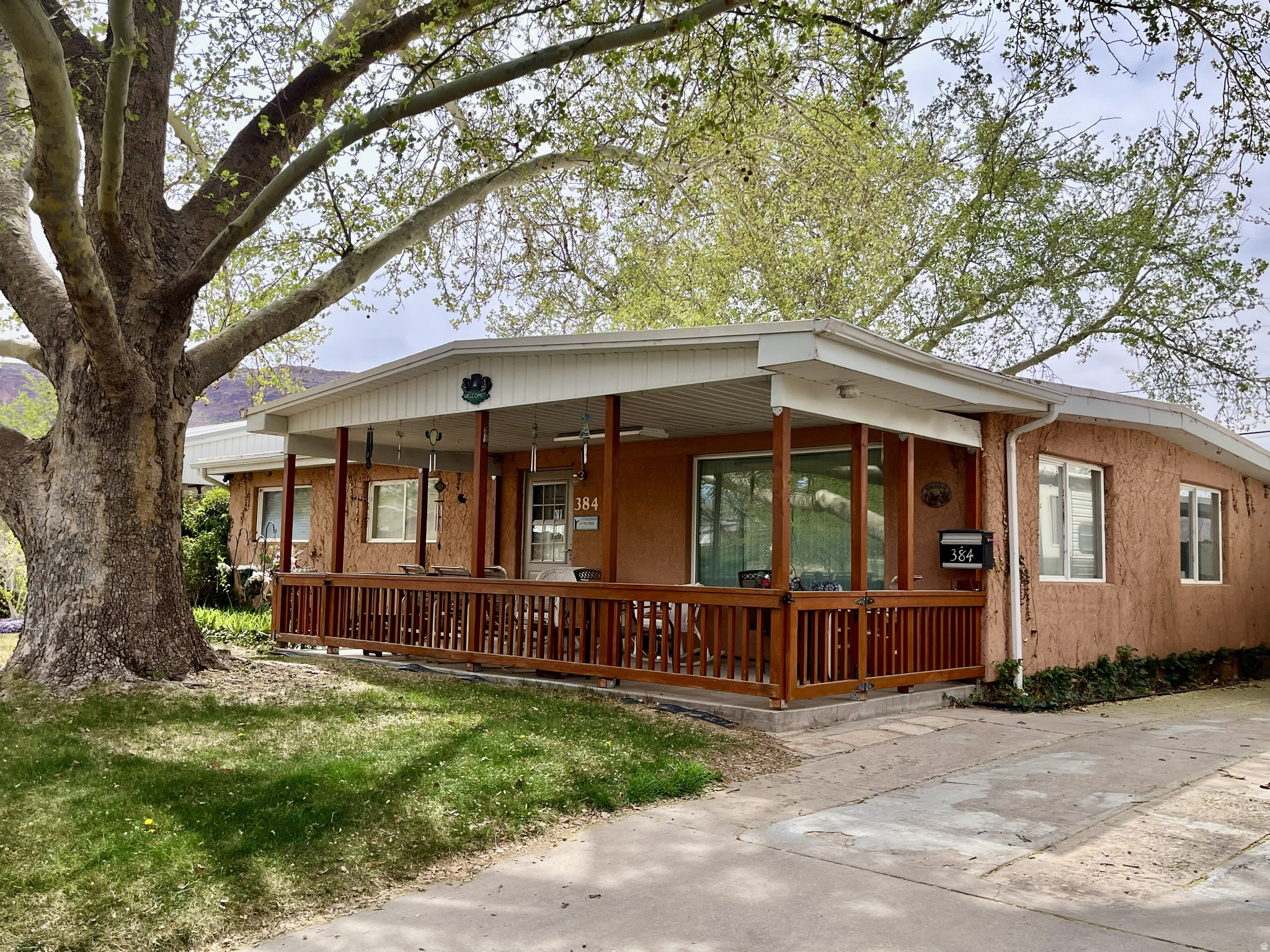 RETRO COTTAGE....READY TO MAKE YOUR OWN. This charming home is tucked in among towering Sycamore trees and features a spacious, covered front porch, lush grass, meandering paths and flowerbeds for your outdoor enjoyment. Inside you will find original oak hardwood floors, retro metal and wood cabinets, new kitchen island, new enlarged windows, and newer bathroom. The central heating/cooling systems are top of the line with Trane A/C, humidifier and gas forced air heat. Outside the kitchen you will find a huge attached, heated pantry/storage that provides plenty of space for your goods and extra appliances. The backyard features multiple storage spaces, an insulated workshop with cabinets, workbench, power, and A/C. This home is set with 110 power hookup and RV cleanout in the driveway. Make this cozy retro cottage your new home! All info is deemed reliable, but buyer to verify all.