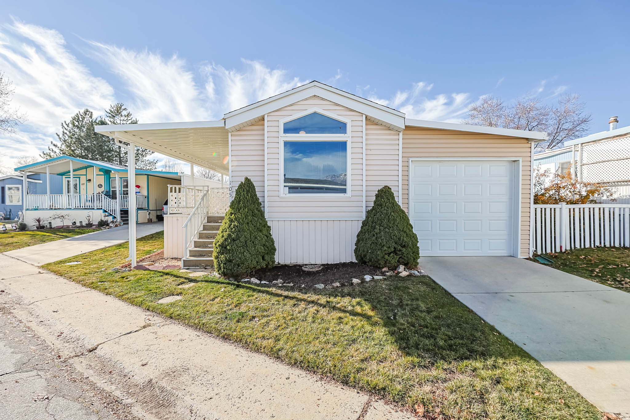 Charming 2 Bed, 2 Bath Home in Westwood Village Park! This well-maintained, move-in-ready home features brand-new LVP flooring, newer carpet, and a bright, open floor plan. Enjoy a large, covered deck with new awning, a 2-car garage, two storage sheds, and a beautifully landscaped yard. Recent upgrades include a new roof, new AC, and new dishwasher. Washer, dryer, and refrigerator are included. Located in the desirable, age-qualified (55+) Westwood Village Park community with a clubhouse, gym, pool, game room, library, and picnic areas. HOA covers water, sewer, trash, and snow removal on the main roads. Seller loved how it was a quiet and safe community and has beautiful mountain views! Sold as-is and priced to sell. Don't miss this one! Buyer and Buyer's Agent to verify all information.