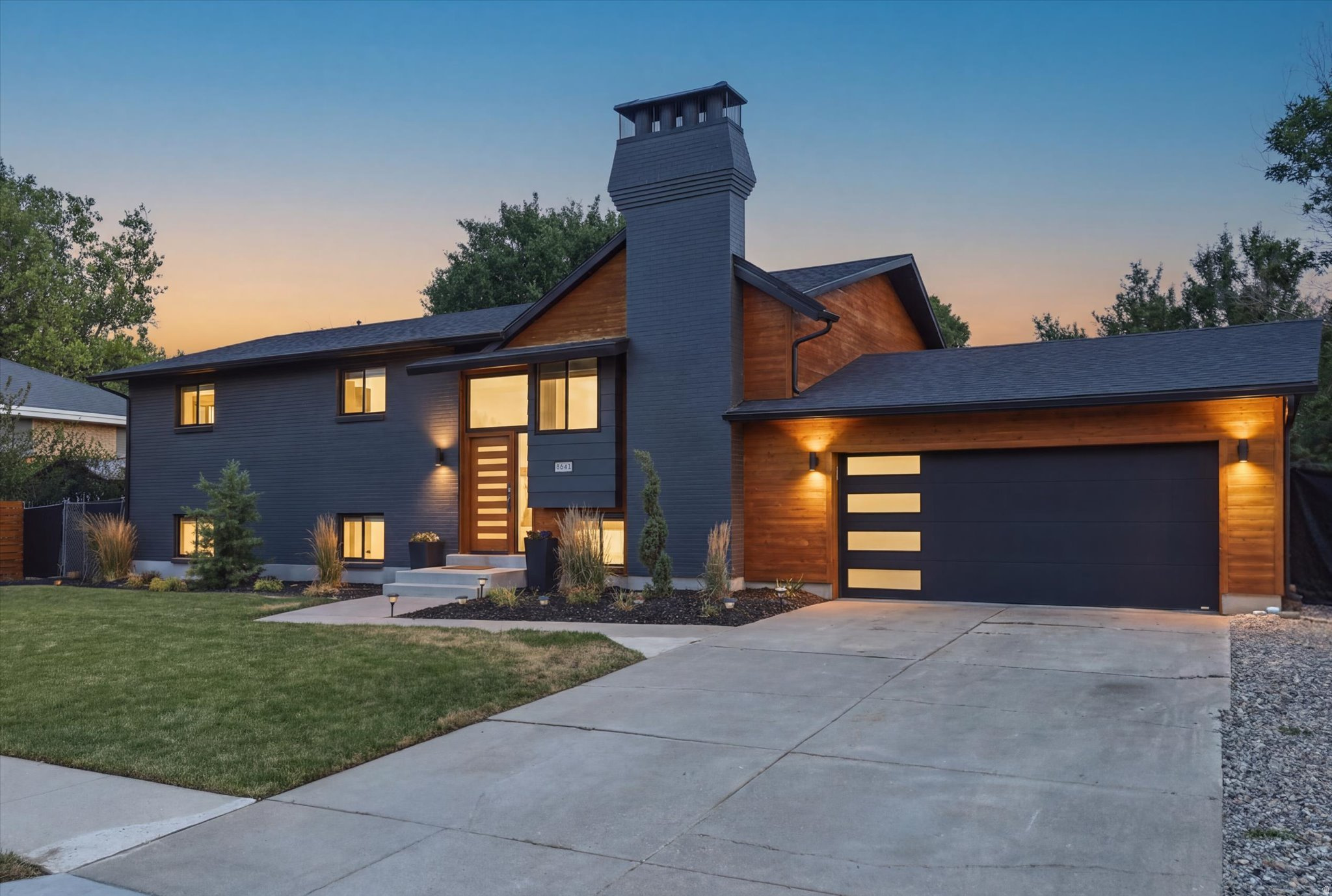 OPEN HOUSE SAT. 1-3!  Stunning contemporary oasis in the heart of Sandy! This beautifully remodeled 5-bedroom, 4-bath home is an entertainer's dream, featuring an open-concept floor plan with a gorgeous quartz island kitchen overlooking the inviting living and dining areas. The spacious primary suite offers room for a sitting area and includes a custom en-suite bathroom. The fully finished Mother-in-Law apartment with a separate entrance includes a large family room, full kitchen with stainless steel appliances, 3 bedrooms, and 2 bathrooms-perfect for multi-generational living or rental potential. Step outside to a park-like backyard that is both a child's dream and an entertainer's retreat. Enjoy a thriving vegetable garden and mature fruit trees, including cherry, plum, peach, apple, and pear. RV parking provides plenty of space for your toys, trailers, and recreational vehicles.  Buyer to verify all information, square footage figures are provided as a courtesy estimate only.