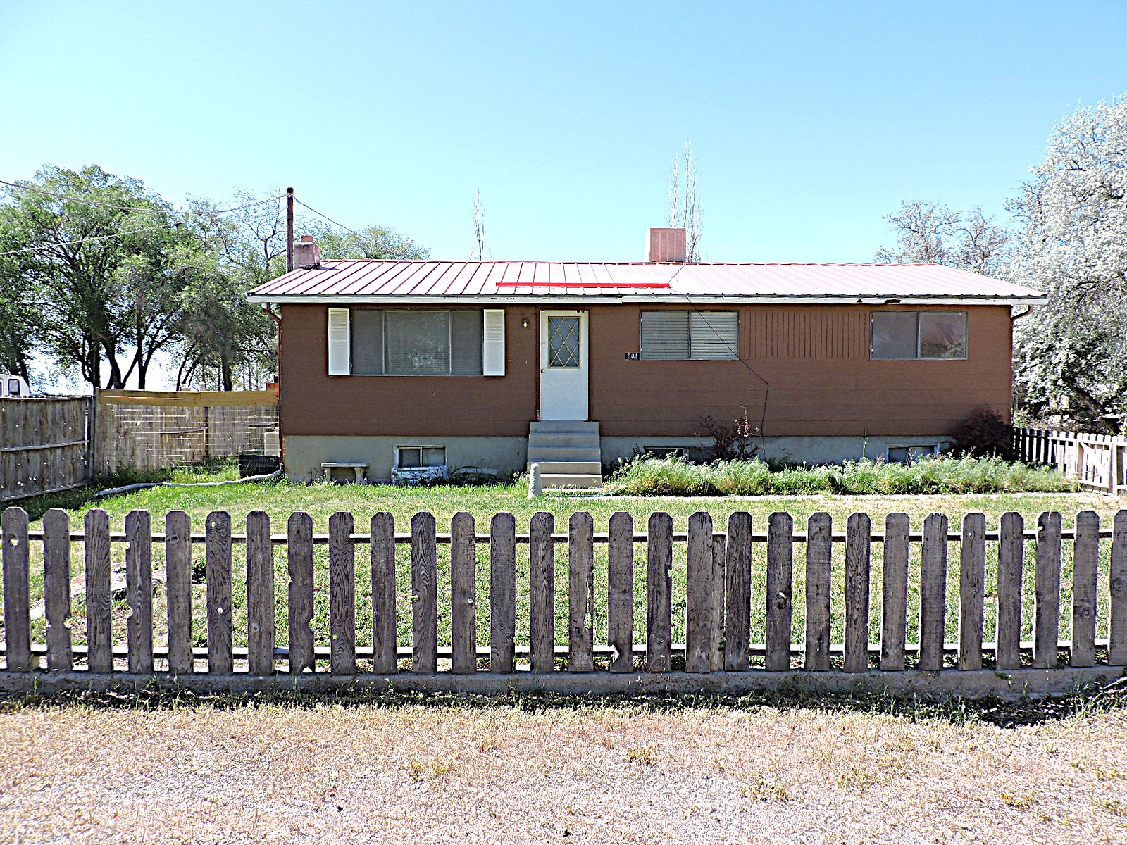 This spacious home offers plenty of room, featuring both a comfortable living room and a large family room with a pellet stove that provides an excellent alternative heat source. The home includes a total of 4 bedrooms and 2 full bathrooms, with a generously sized primary bedroom. Situated on 0.51 acres in a small community, the property allows for large animals and offers space for all your toys. Ready for its new owner, this property combines comfort, functionality.