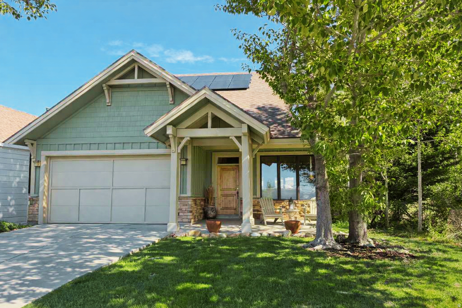 Welcome to this well maintained, fully furnished two-story residence situated in the sought-after Trappers Ridge community of Eden, Utah. Owned and cared for by the original owner, this home occupies a premium corner lot with no anticipated adjacent development, ensuring privacy and preserving the tranquility of its natural surroundings. Enjoy breathtaking views of Pineview Reservoir, Snowbasin Resort, and the Ogden Valley. Ski enthusiasts will appreciate the convenience of the Powder Mountain ski bus stop located just at the corner, offering effortless access to world-class skiing. This thoughtfully designed home features three bedrooms and three bathrooms, perfectly blending comfort with practicality for year-round mountain living or short-term rentals. Added benefits include fully paid solar panels and a Level 2 Wallbox electric vehicle charging station, providing eco-friendly appeal. Step inside to discover an open and airy main living area adorned with generously placed windows that flood the space with natural light while framing stunning views. Vaulted ceilings with exposed beams and a cozy fireplace create an inviting ambiance ideal for both relaxation and entertaining. The main level also includes a convenient guest bathroom and an eat-in kitchen that seamlessly flows into the family dining room, providing ample space for gatherings and everyday living. The primary suite on the main floor offers privacy and ease of access, featuring a spacious ensuite bathroom and a generous walk-in closet. Upstairs, two additional bedrooms, an office area, and a large bathroom offer versatile options for guests, family members, or a home workspace. An extra bonus room is perfect for storage, a secure owner's closet, or a children's playroom. Outside, a spacious patio surrounded by mature landscaping provides natural privacy and a serene retreat, ideal for morning coffee, twilight dinners, barbecues, or enjoying the outdoors throughout the seasons. The homeowners association enhances the living experience with resort-style amenities, meticulous landscaping, and beautifully maintained common areas. This remarkable home harmonizes comfort, elegant design, and a prime location just minutes from premier skiing, hiking, and the natural splendor of Ogden Valley. It represents a rare opportunity in one of Eden's most coveted neighborhoods. With short-term rentals permitted, this property also offers excellent investment potential.
