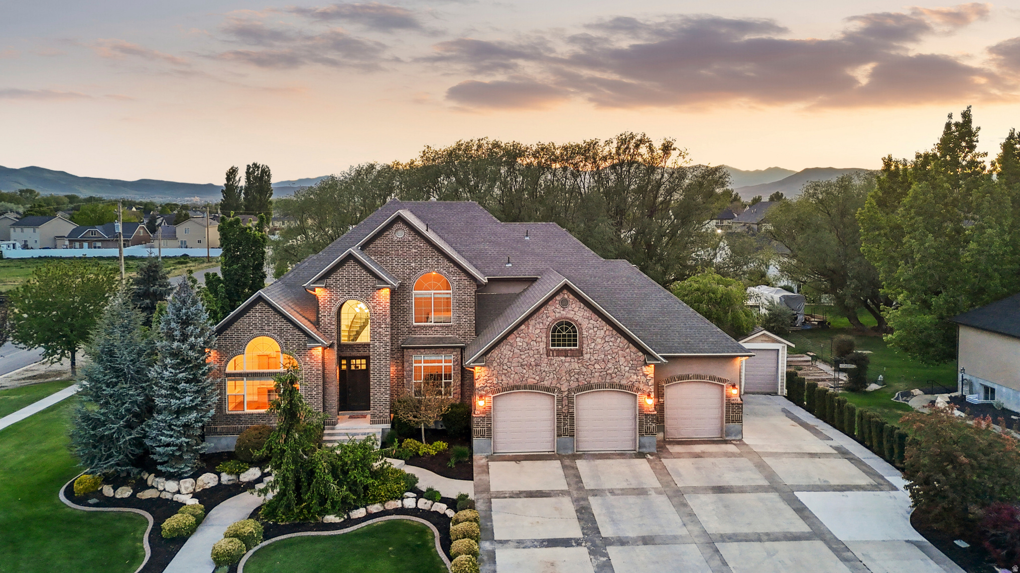 Country living in the heart of the city on a HALF Acre with Splash pad and a gorgeous yard! No showings until after open house on May 9th. This one-of-a-kind Lehi property offers breathtaking mountain and lake views, a peaceful setting, and the rare combination of privacy, space, and convenience. Situated on a beautifully landscaped half-acre lot in a quiet neighborhood, this home truly has something for everyone. The backyard is an entertainer's dream featuring mature trees, a stunning evening-shaded deck, splash pad, two storage sheds, and an incredible $40,000 playhouse. Surrounded by neighboring farms and open space, you'll love the serene country feel while being just minutes from the freeway, Costco, shopping, restaurants, and everyday amenities. Built by a custom builder, the quality and craftsmanship are evident throughout. The home features main-floor living, vaulted ceilings, real hardwood flooring, travertine finishes, and high-end details at every turn. Unique hidden spaces include a secret kids' playroom and a vault room. The fully approved ADU/mother-in-law apartment has its own private entrance and separate address, offering incredible flexibility for multigenerational living or rental income potential. It only needs a kitchen to be fully completed, there was a kitchen previously so all connections are stubbed and already installed. The ADU is currently being used as an Amazon shipping business and could easily be converted into additional rentable space to help offset your mortgage. The theater room is ready for movie nights with a wet bar, wired surround sound speakers, and a negotiable 100" TV.  The luxurious primary suite is hard to beat with vaulted ceilings, a cozy fireplace, dual walk-in closets, and a private deck to enjoy the incredible views. Homes like this rarely come available - combining custom luxury, income potential, outdoor living, and unmatched location all in one exceptional property.