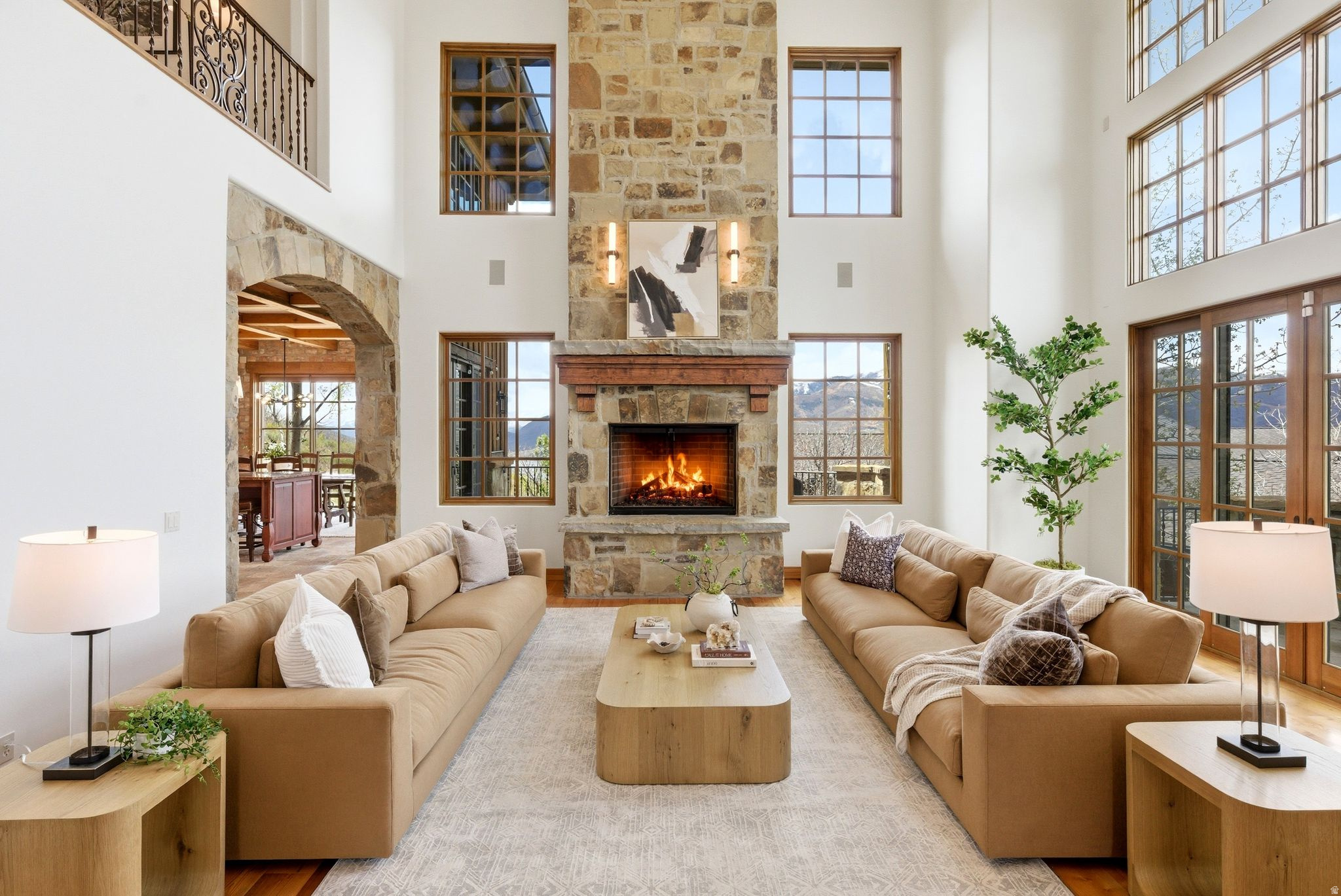 **YOU CAN RENOVATE A HOME. YOU CAN NEVER RECREATE ITS LOCATION.** .Long before Hideout Canyon became one of the Wasatch Back's most sought-after communities, one homesite was chosen above all others. Perched high above the Jordanelle Reservoir, this was the very first home built in Hideout Canyon, strategically positioned to capture panoramic views stretching from Deer Valley Resort and Mayflower Mountain Resort to the majestic peaks of Mt. Timpanogos.  Offering 8,653 square feet, this remains the largest residence in the community, combining a premier location, exceptional scale, and breathtaking scenery in a way that simply cannot be replicated.  From the moment you enter, natural light pours through expansive windows that frame spectacular mountain and reservoir views from nearly every room. The soaring great room serves as the heart of the home, where dramatic ceilings, rich hardwood flooring, a statement fireplace, fresh paint, and updated designer lighting create a warm yet sophisticated atmosphere.  Designed for both everyday living and grand entertaining, the chef's kitchen is equipped with Thermador appliances, a six-burner gas range with griddle, double ovens, a warming drawer, and an oversized island that naturally becomes the gathering place for family and friends. A six-seat breakfast bar and dedicated dining space allow every meal to be accompanied by unforgettable views and the glow of a cozy fireplace.  Outdoor living is equally extraordinary. A wraparound balcony showcases the surrounding landscape from every angle, while the stone patio, manicured lawn, and firepit create inviting spaces to gather beneath the stars. Beyond the backyard lies protected BLM land, preserving both privacy and the unobstructed vistas of the Jordanelle Reservoir below and Deer Valley ski slopes above.  The thoughtfully designed floor plan offers exceptional flexibility. The main level features two en-suite bedrooms and a dedicated office. Upstairs, a dramatic mezzanine overlooks the great room below, leading to a luxurious primary retreat complete with panoramic views, a private fireplace, and heated bathroom floors. An additional en-suite bedroom with its own private deck completes the upper level.  The walkout lower level lives unlike a traditional basement, with abundant natural light, expansive views, and seamless outdoor access. Here you'll find a second full kitchen, spacious family room, dedicated theater room, wine room, bunk room with en-suite bath, and additional guest amenities, creating the ideal space for hosting family and friends year-round.  Perfectly positioned just minutes from Deer Valley Resort, Park City Mountain, Jordanelle Reservoir, championship golf courses, and Historic Main Street Park City, the home offers immediate access to world-class recreation in every season while remaining just 45 minutes from Salt Lake City International Airport.  This is more than a luxury home. It is the original crown jewel of Hideout Canyon, occupying the community's most iconic homesite and offering a lifestyle defined by views, privacy, scale, and permanence.